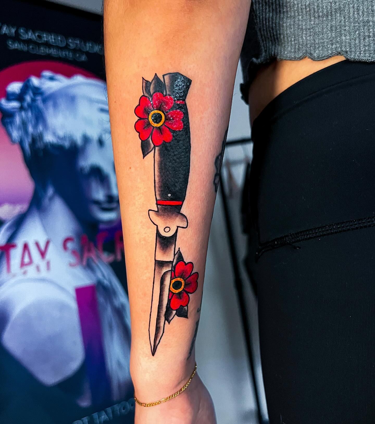 Knife with flowers American traditional tattoo on the forearm by Ashley Fino, Las Vegas, Nevada
