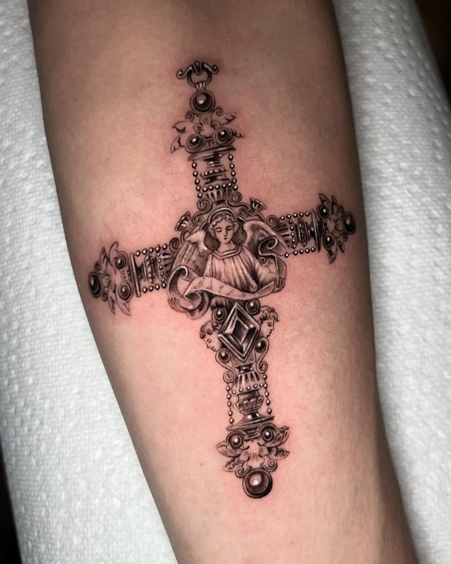 Cross with angel ornamental tattoo on the forearm by Single Needle ๐ชฉ