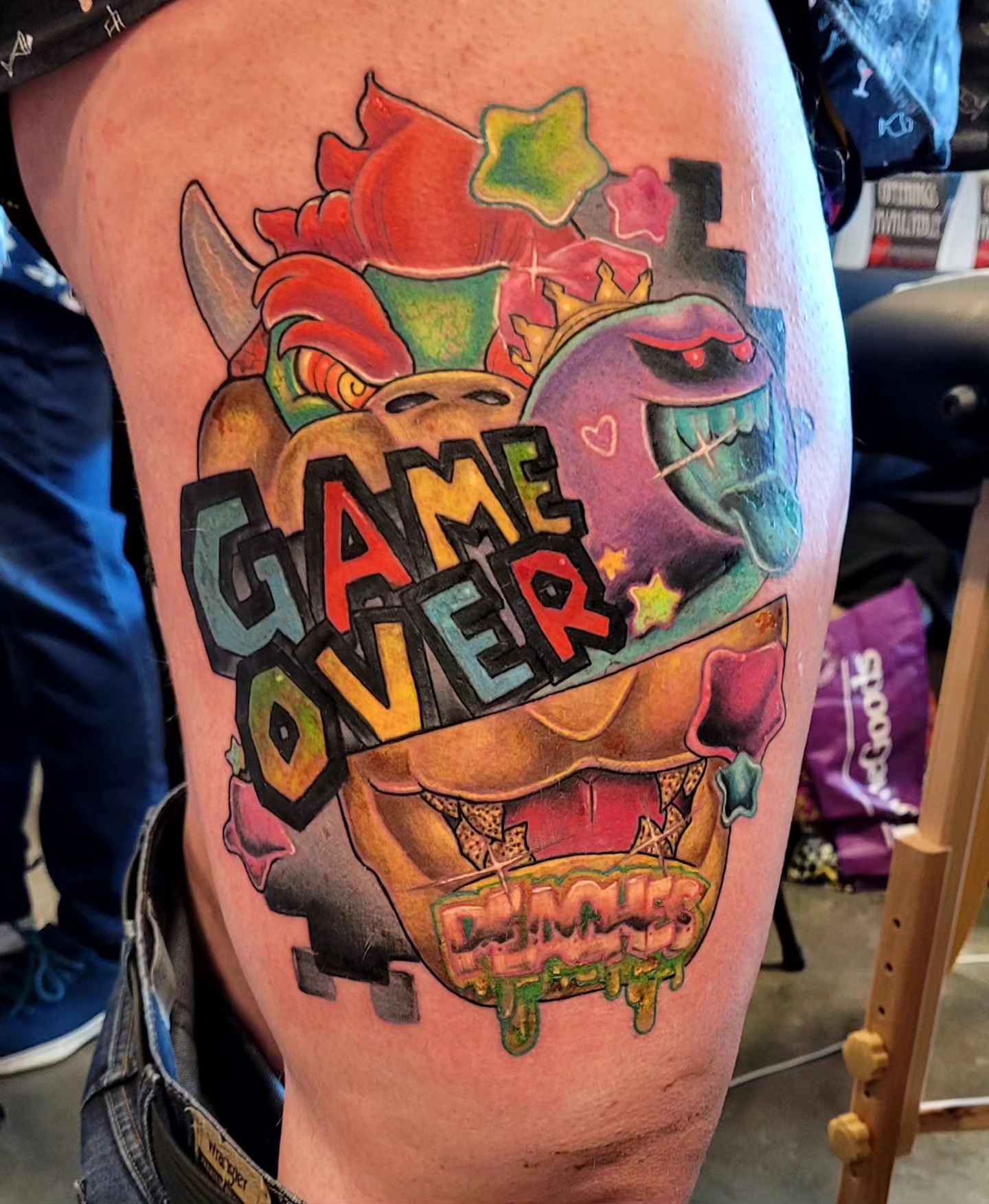 Game over new school tattoo on the thigh by Dawne Michele