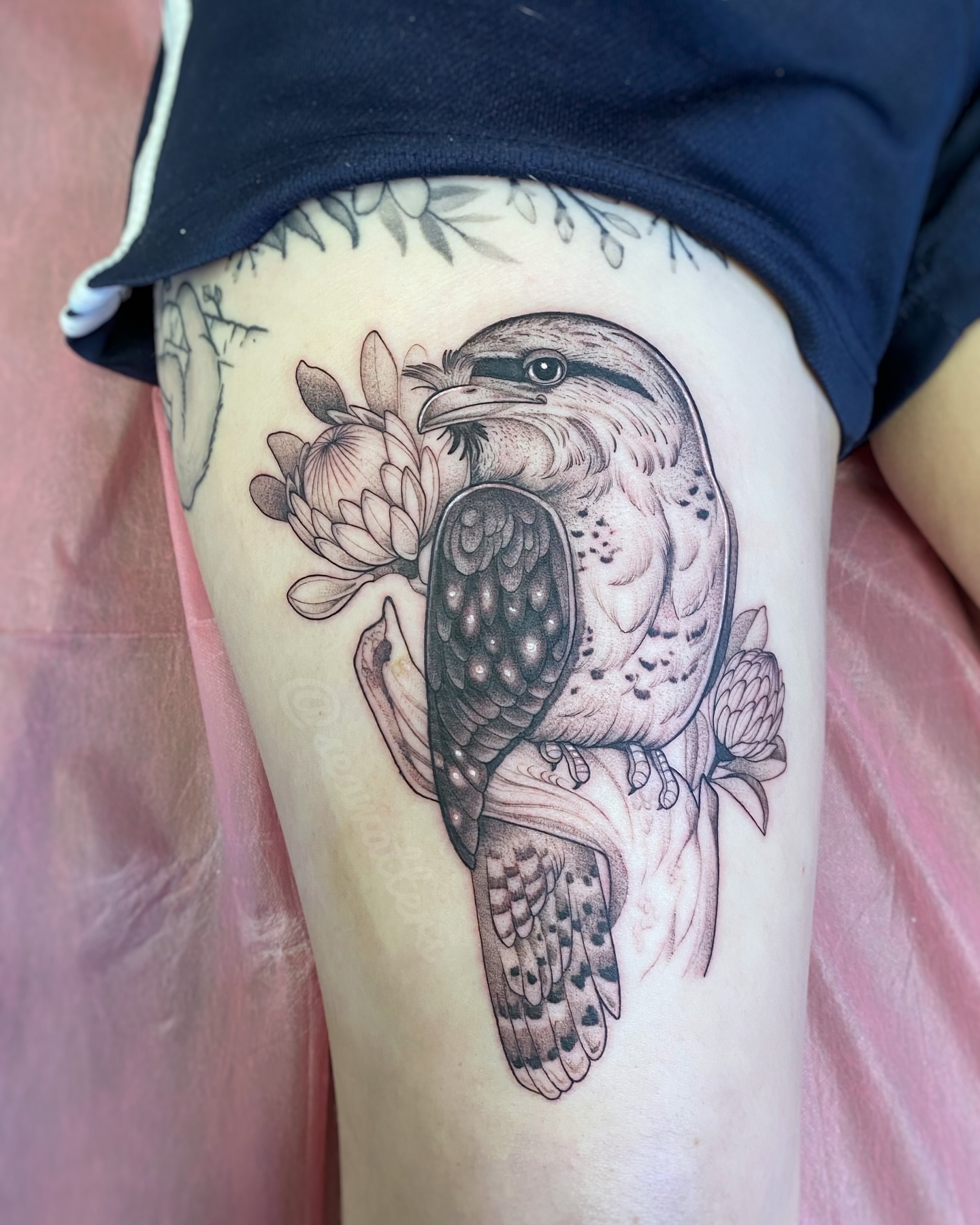 Bird and flowers dotwork tattoo on the thigh by Caitlin Watters