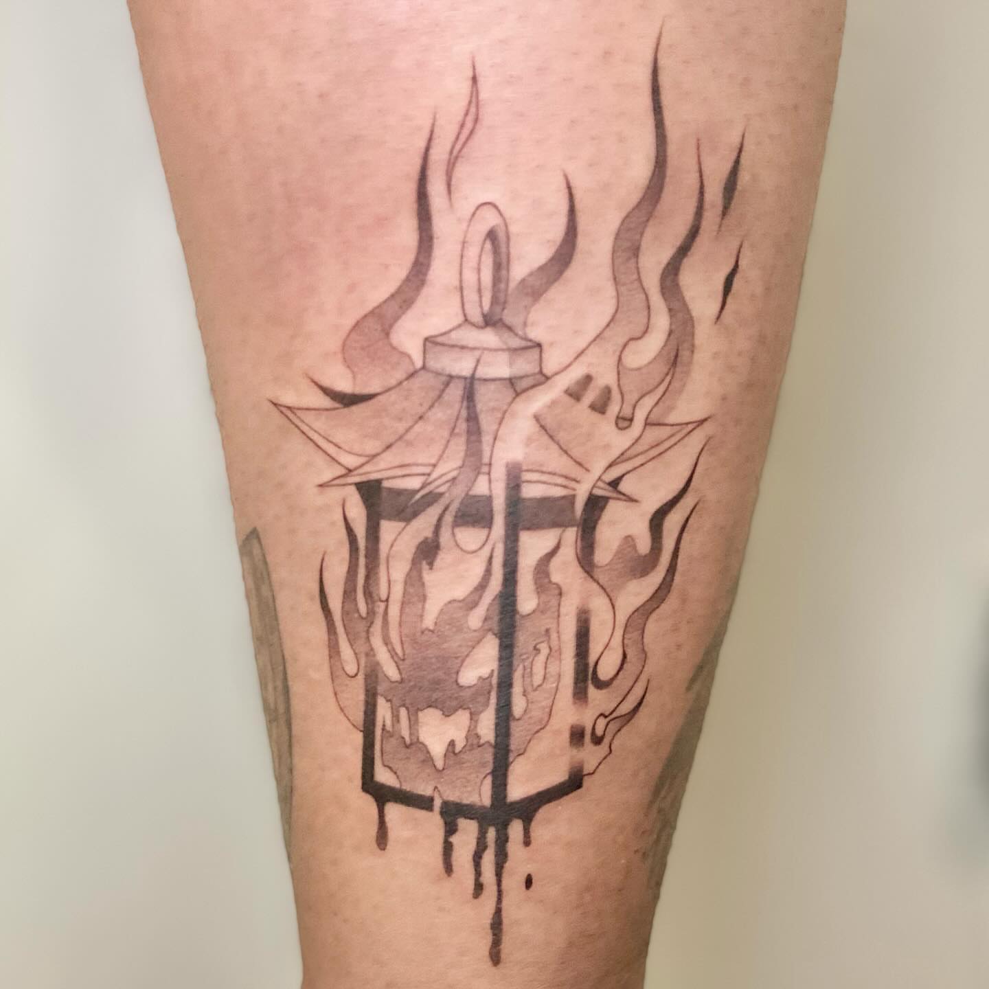 Lantern with flames black and grey tattoo on the calf by seattle tattoo artist