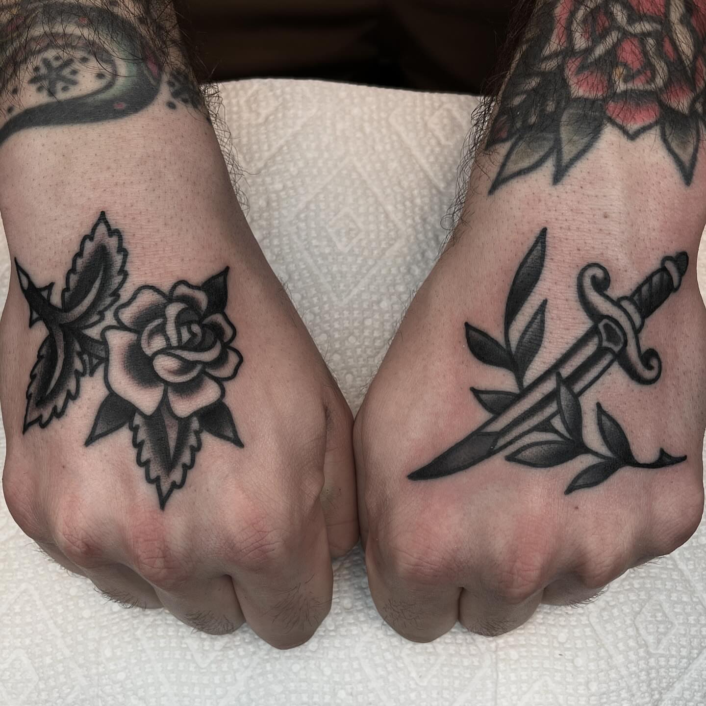 Rose and dagger American traditional tattoo on the hand by John Lemon