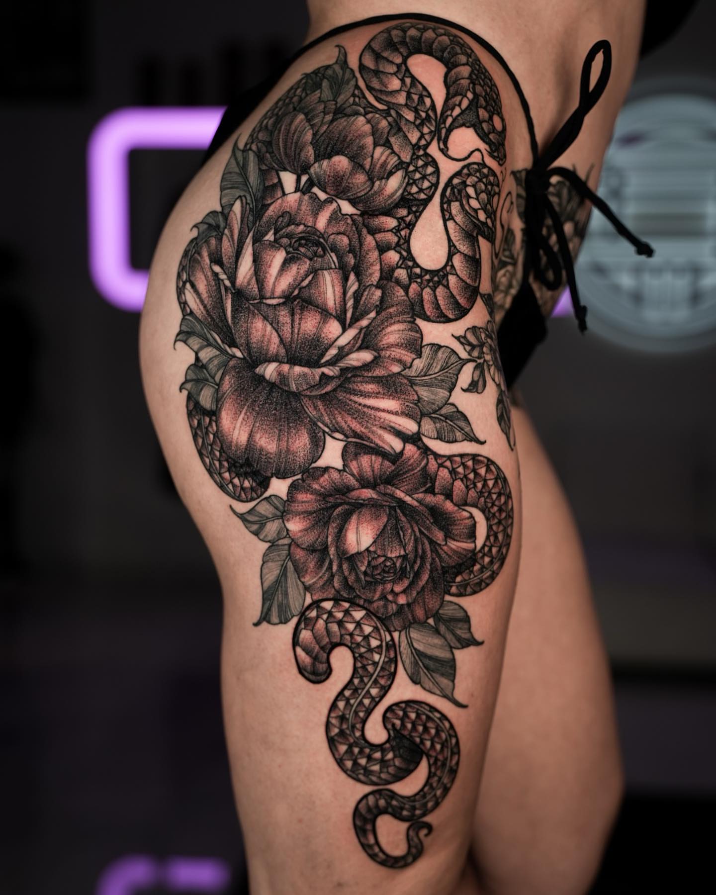 Snake and peony realism tattoo on the thigh by Stacy Lavette