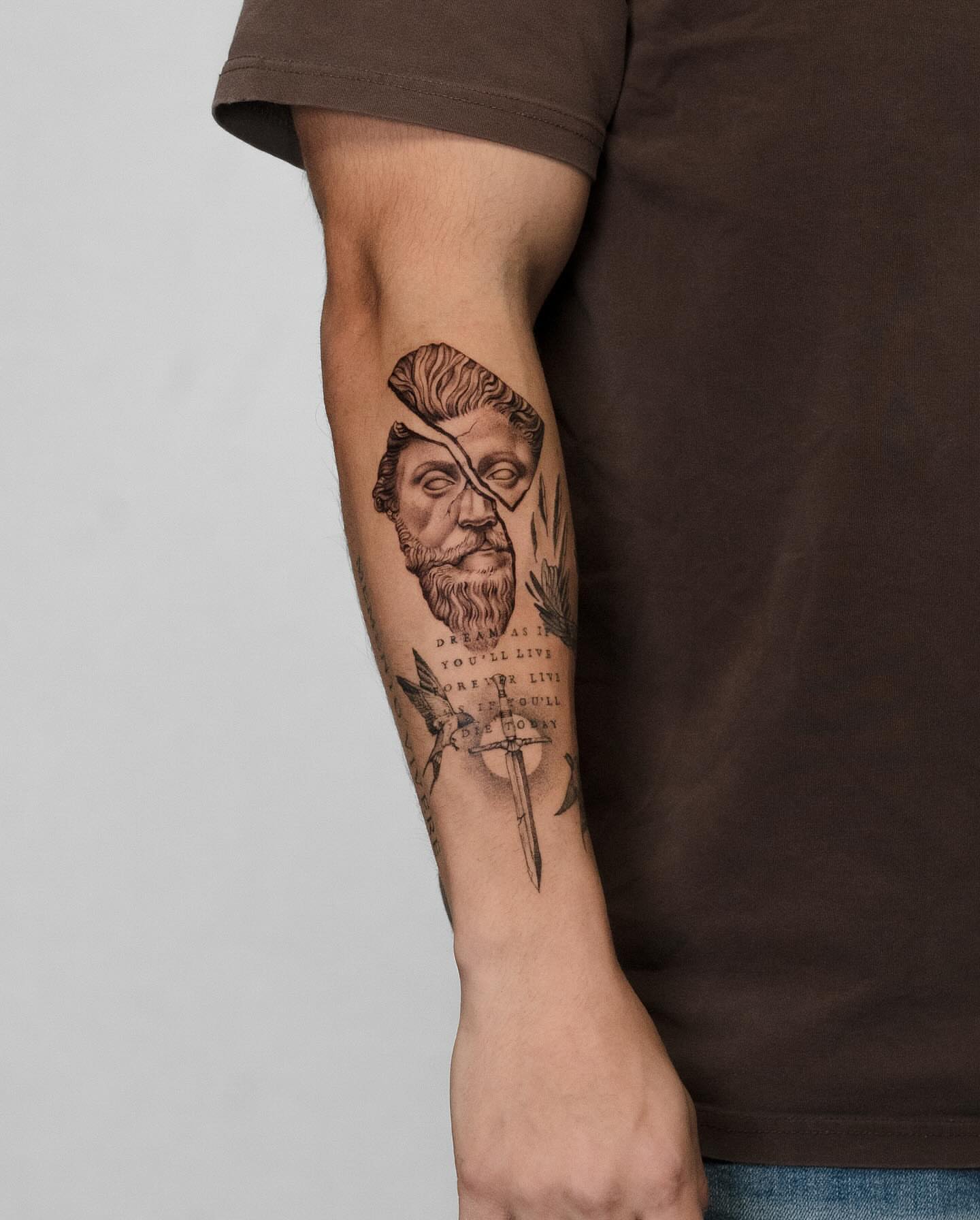 Bearded man's head black and grey tattoo on the forearm by Mateo