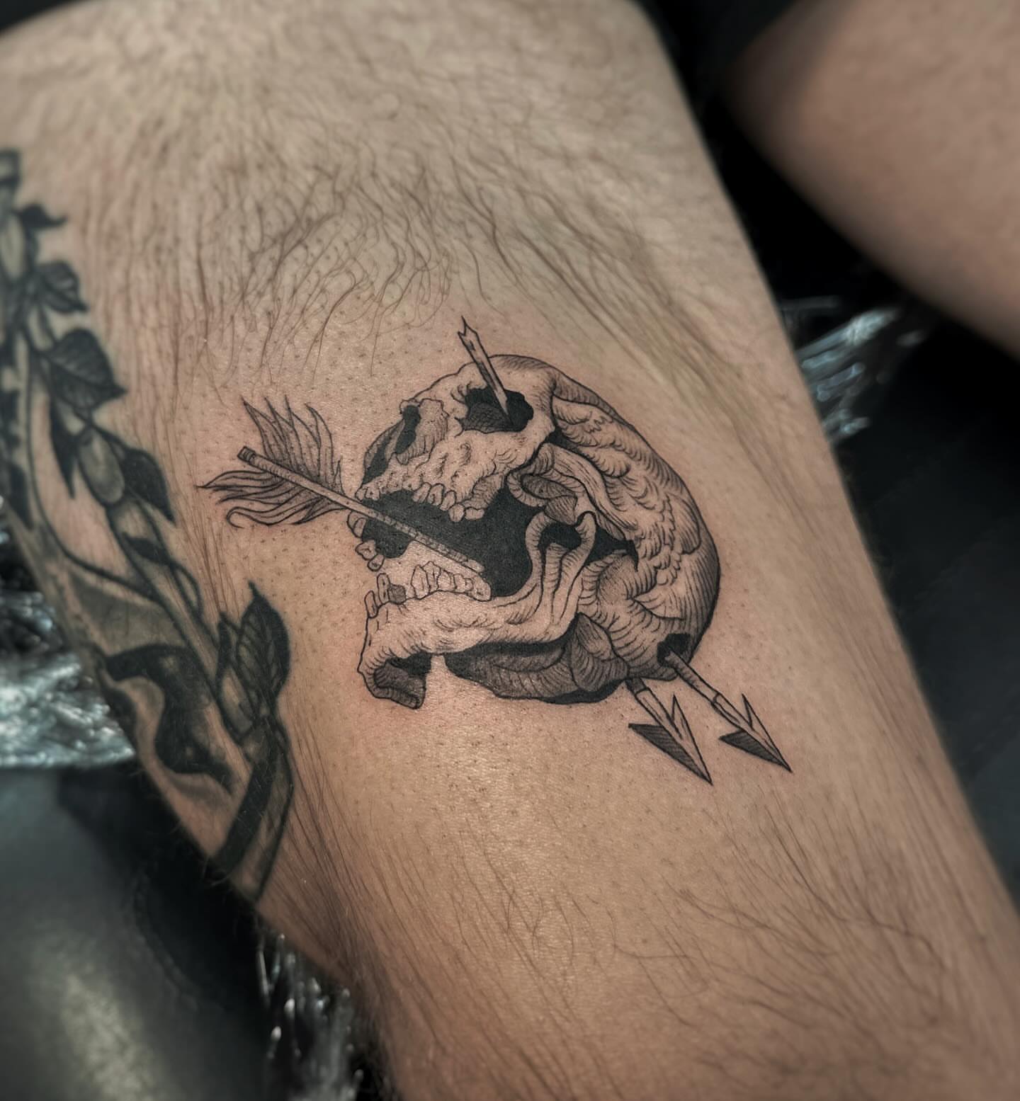 Skull with arrows realism tattoo on the thigh by Lily K.