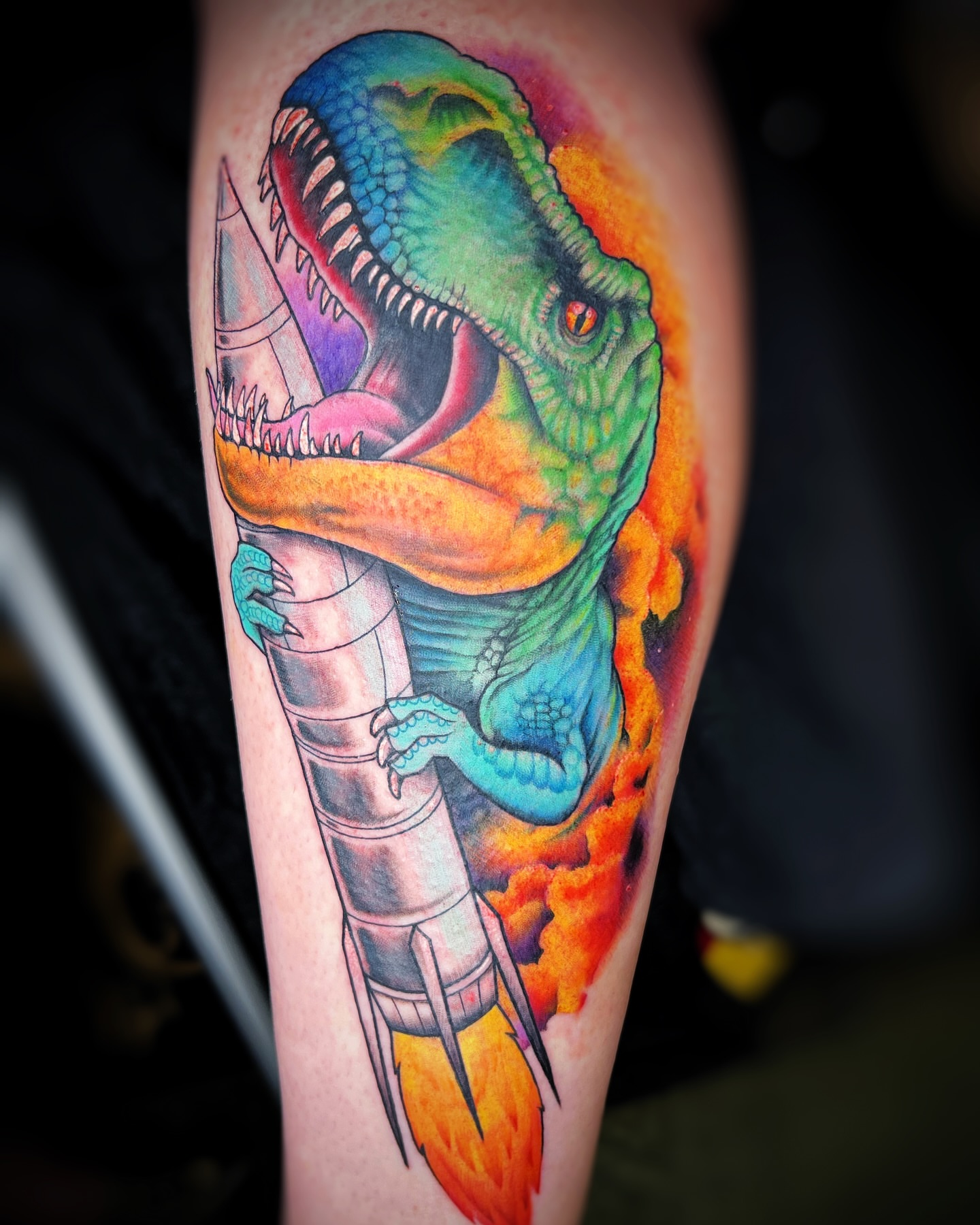 T-Rex with rocket realism tattoo on the forearm by Tattoos by Hanna, Farmington Hills, Michigan