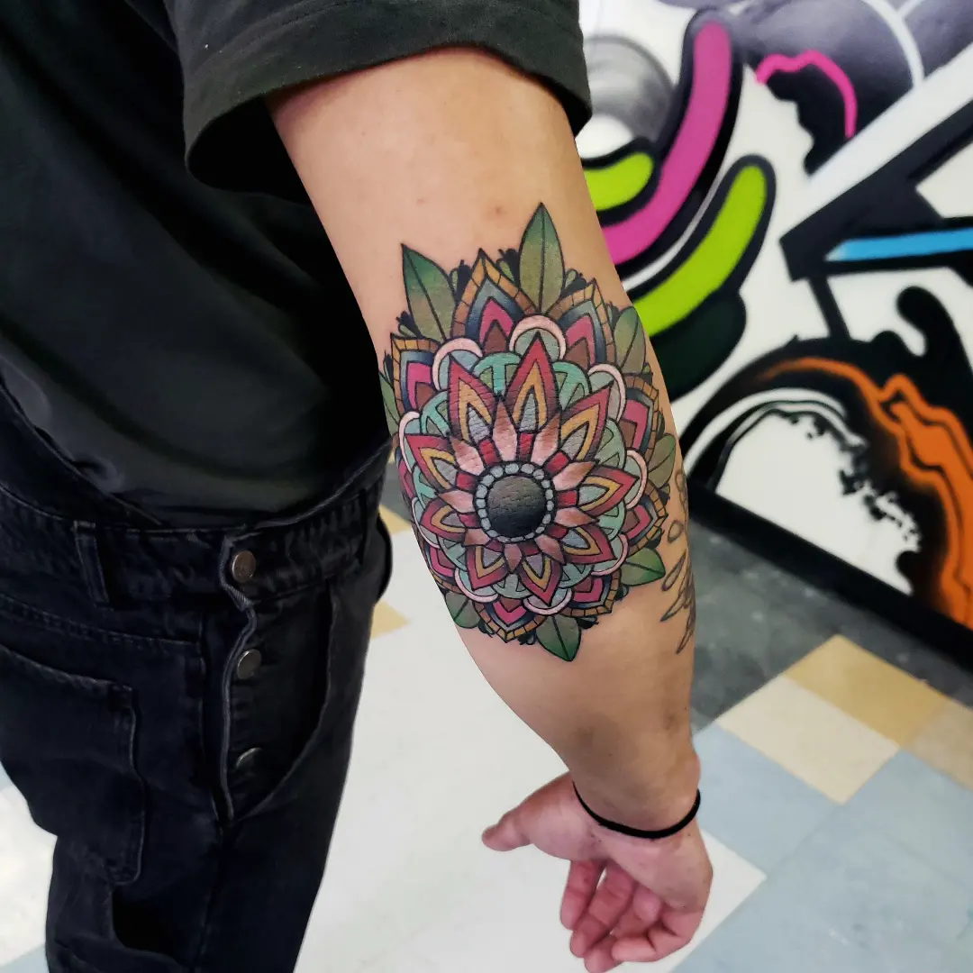 Mandala geometric tattoo on the forearm by Jake Lee