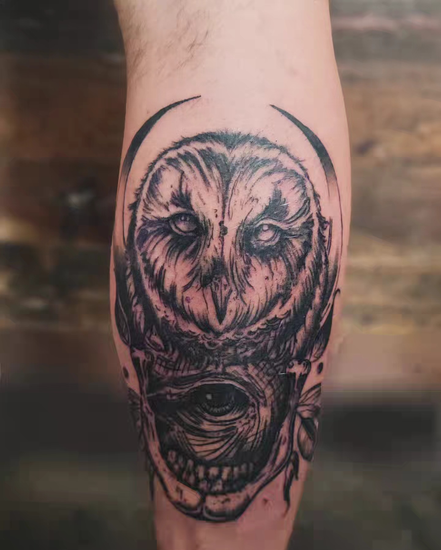 Owl skull dark realism tattoo on the forearm by Tim Andrews