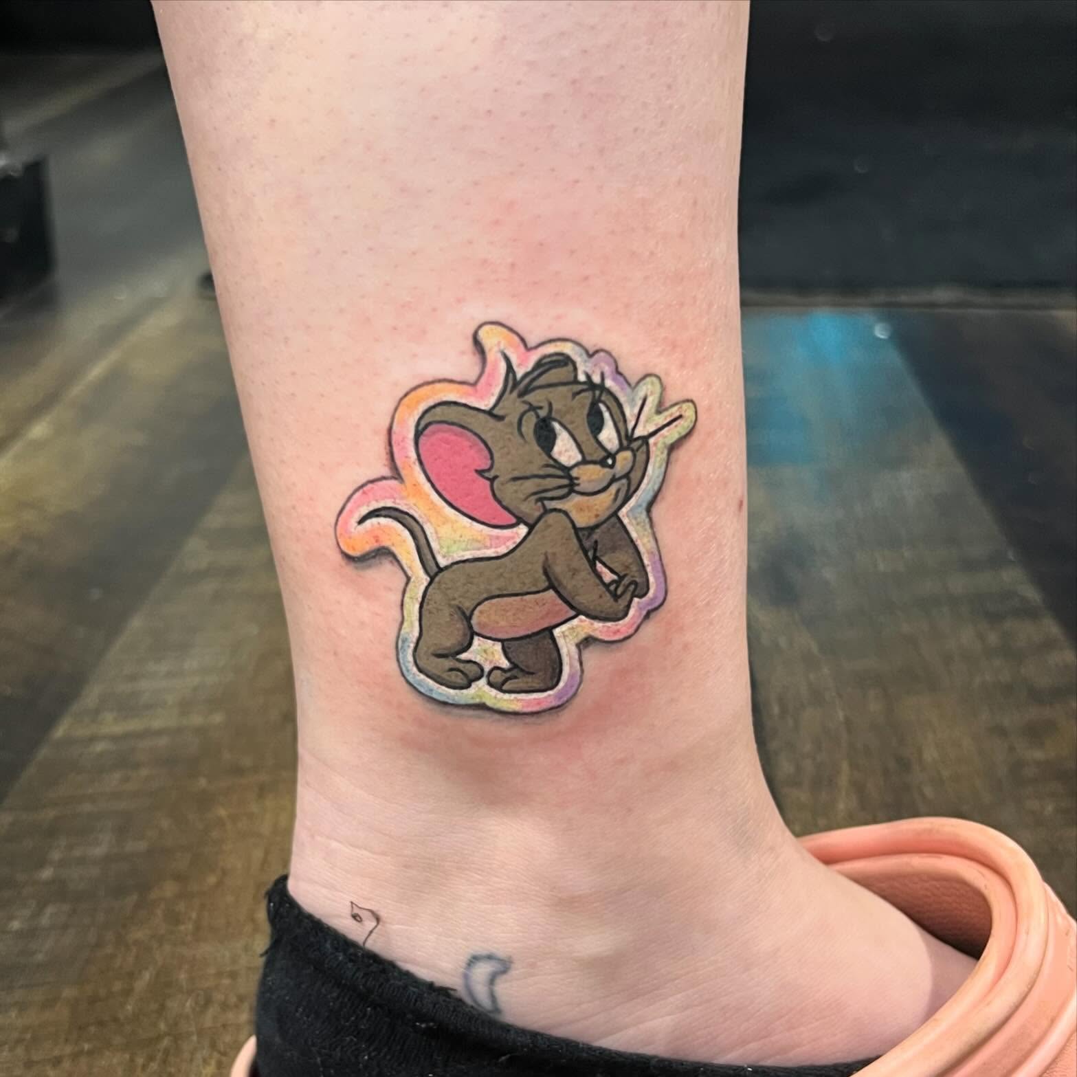 Tom and jerry new school tattoo on the forearm by Seth Scott