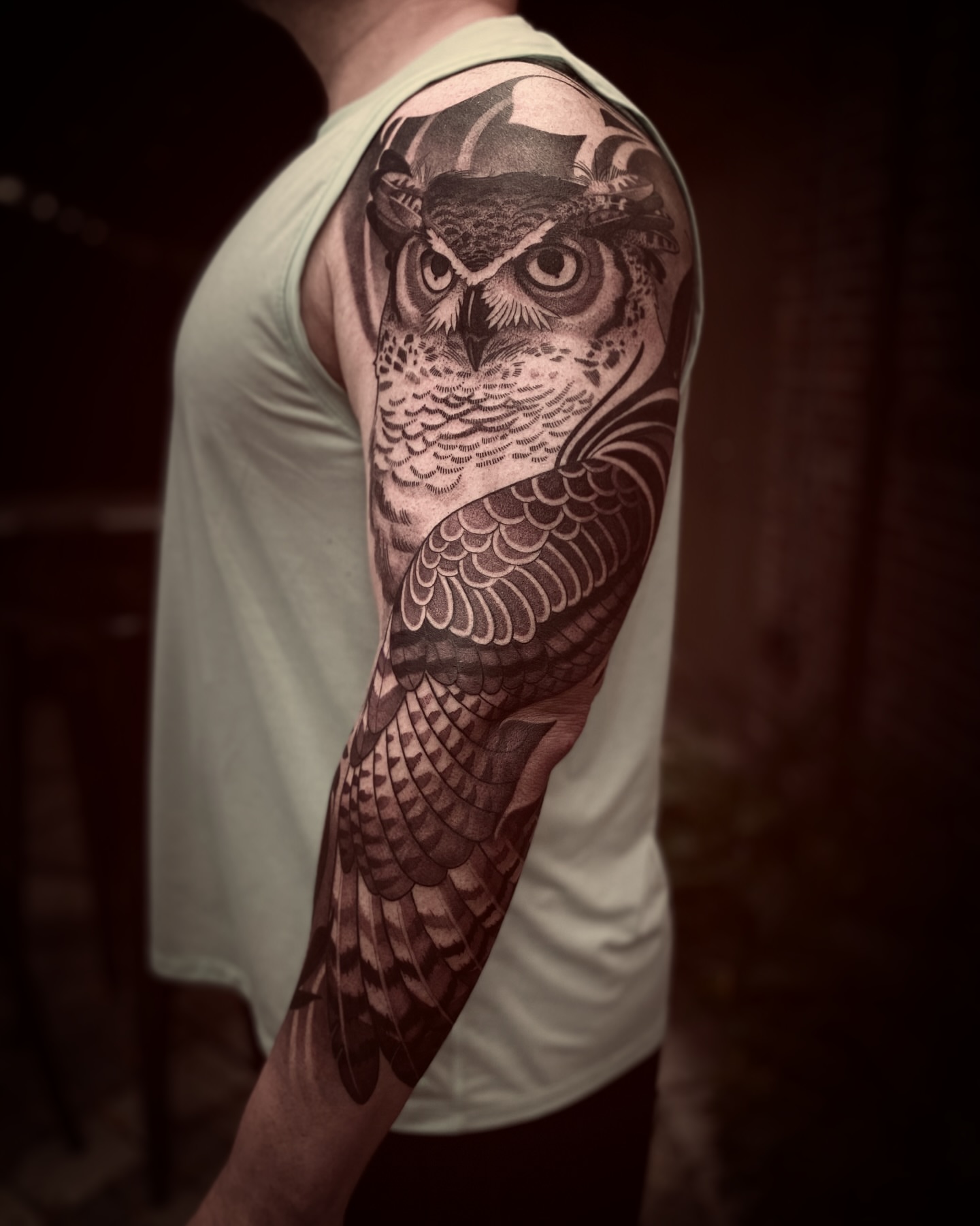 Owl realism tattoo on the upper arm by Natasha Dickinson