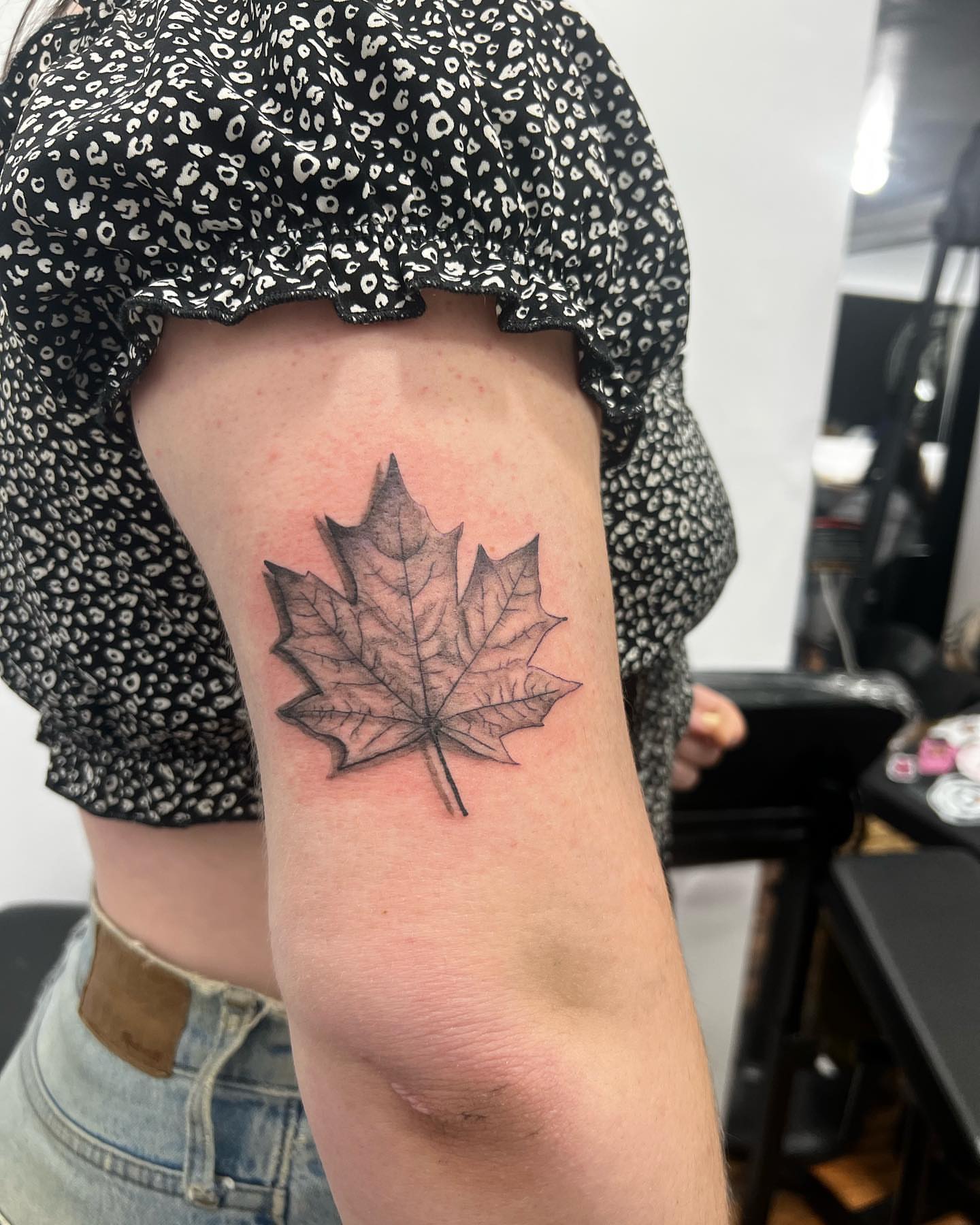 Maple leaf black and grey tattoo on the forearm by Eduardo Chaparro
