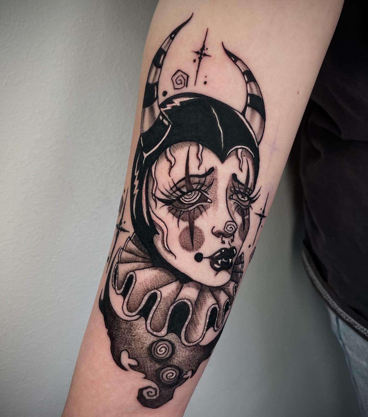 Clown dark realism tattoo on the forearm by Kathryn the Tooth Collector