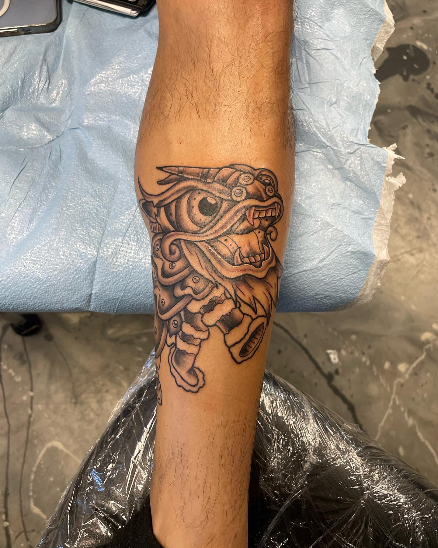 Mask black and grey tattoo on the forearm by Brandon Anderson