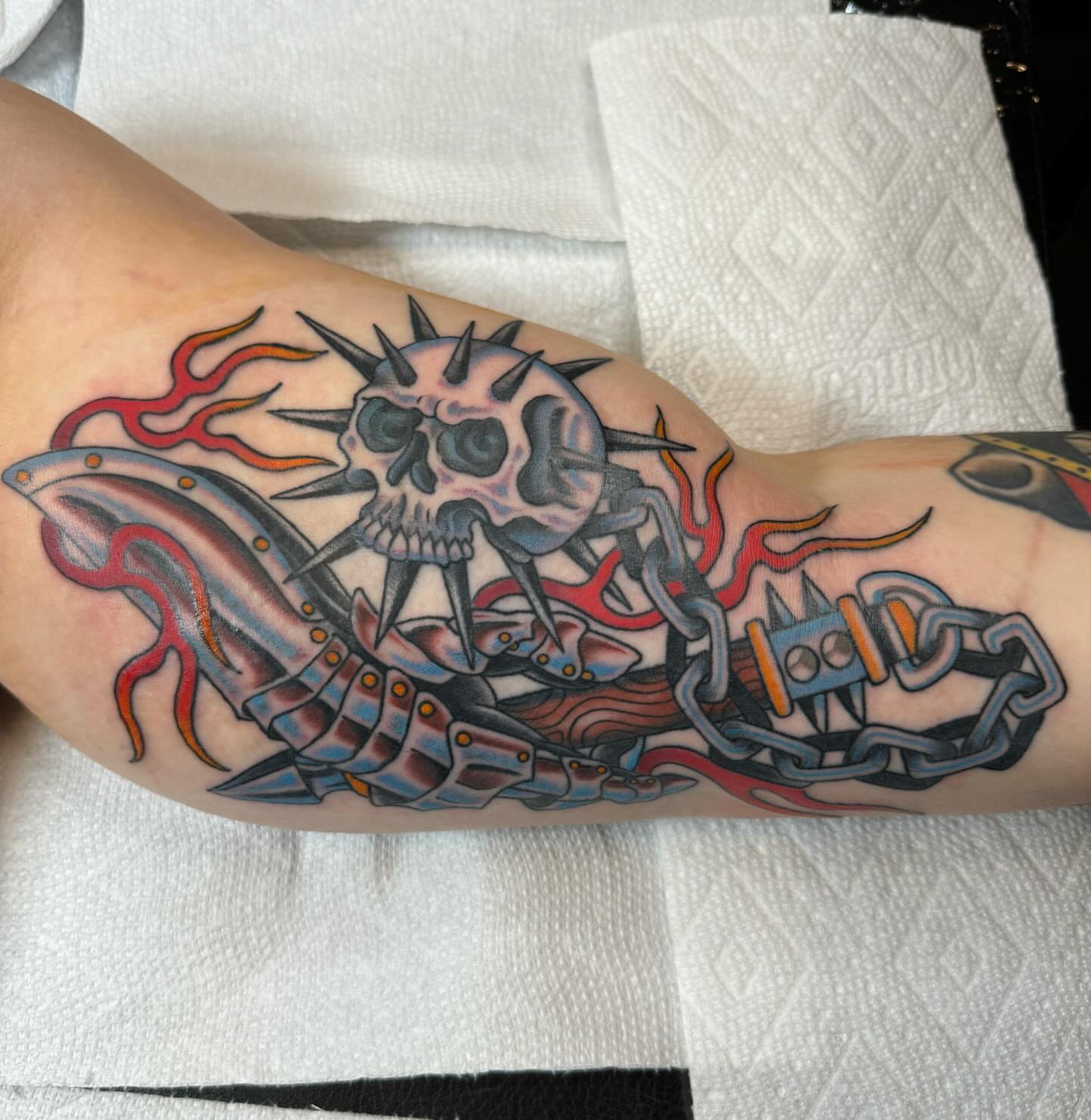 Skull and chains neo-traditional tattoo on the forearm by Ethan Bennett