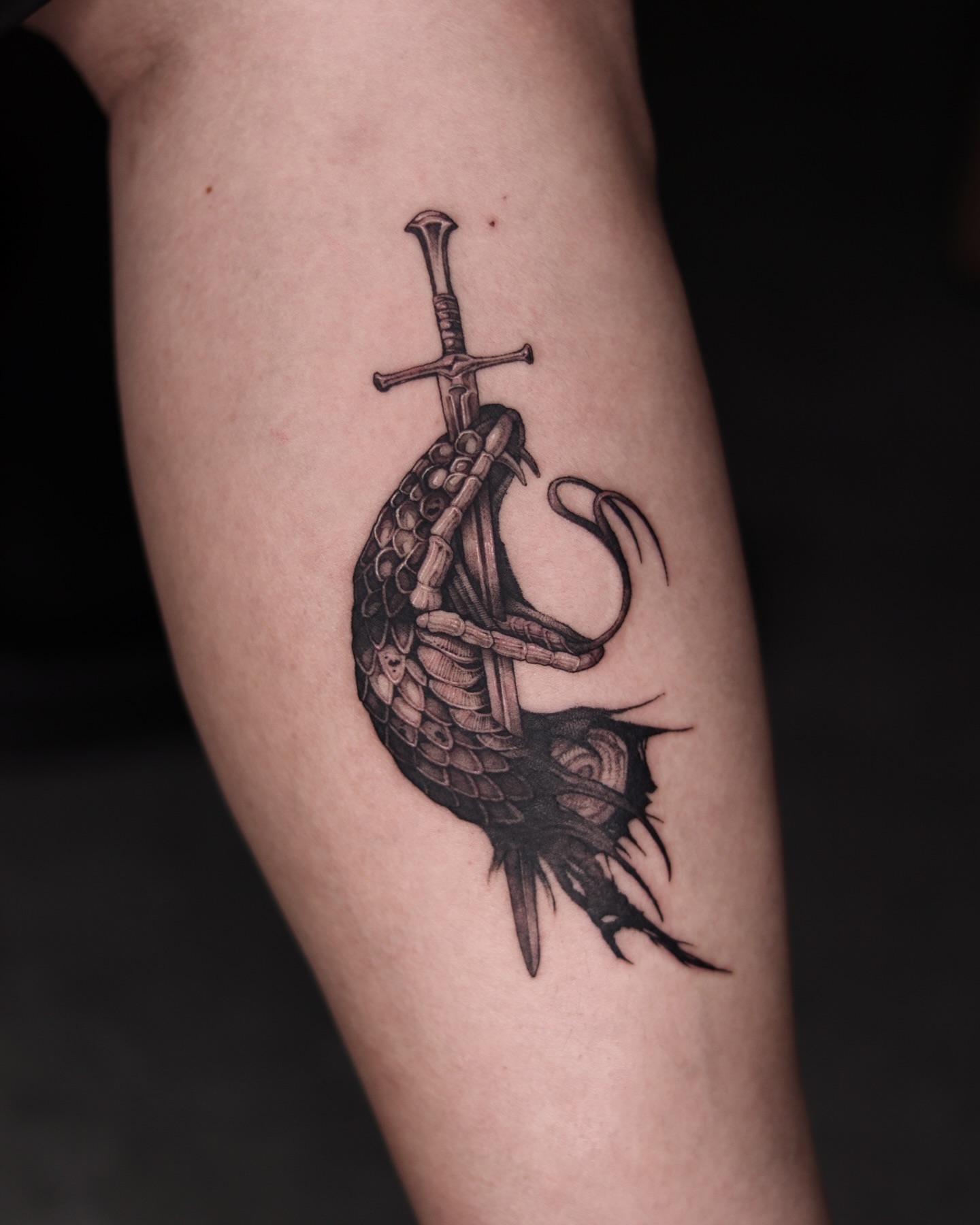 Sword and fish realism tattoo on the forearm by Blackwork A P S O