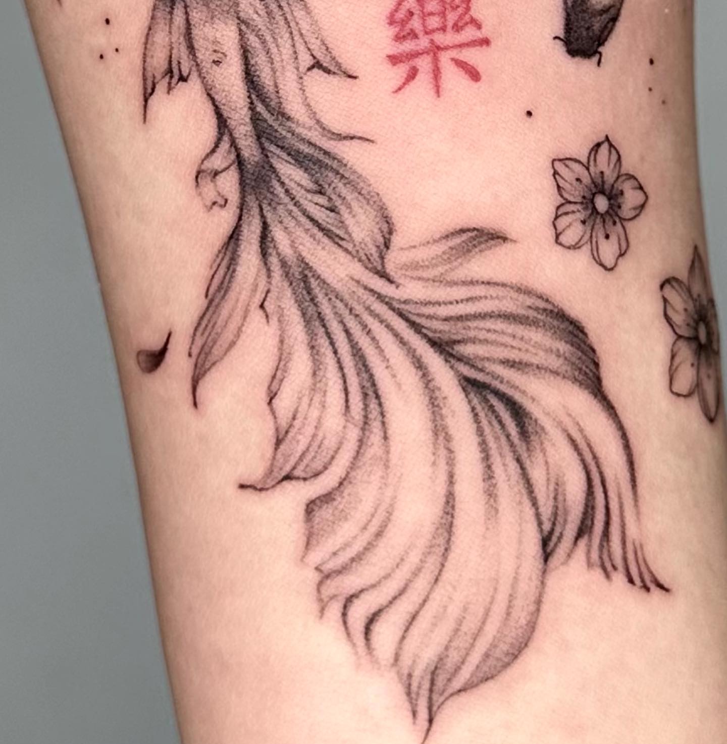 Mermaid tail black and grey tattoo on the forearm by Sophia Delfino