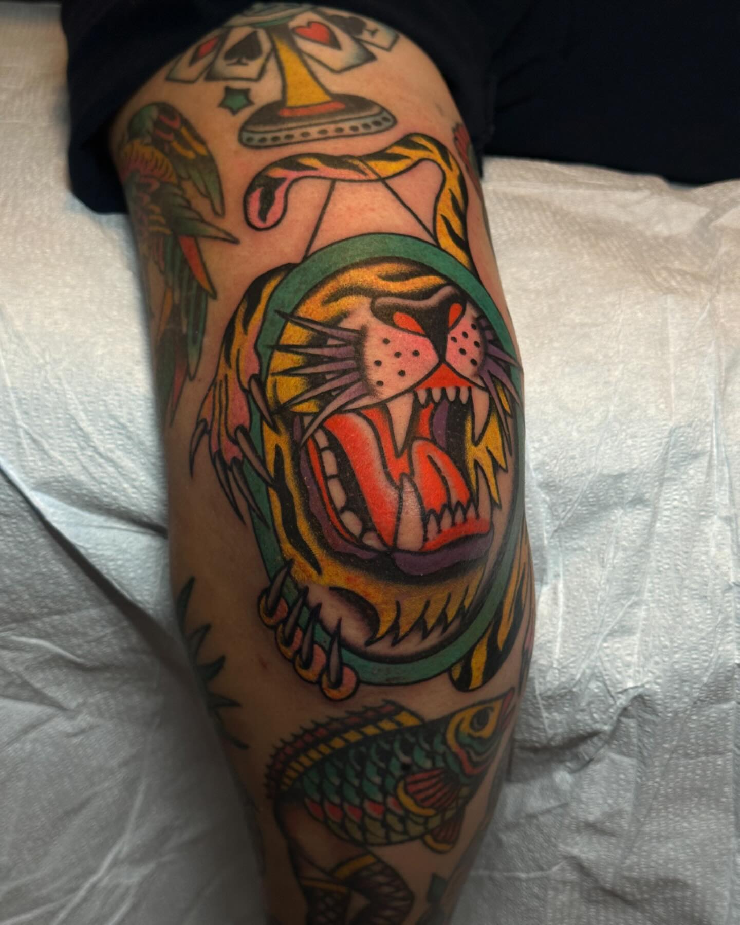 Roaring tiger American traditional tattoo on the thigh by Britney Goodman