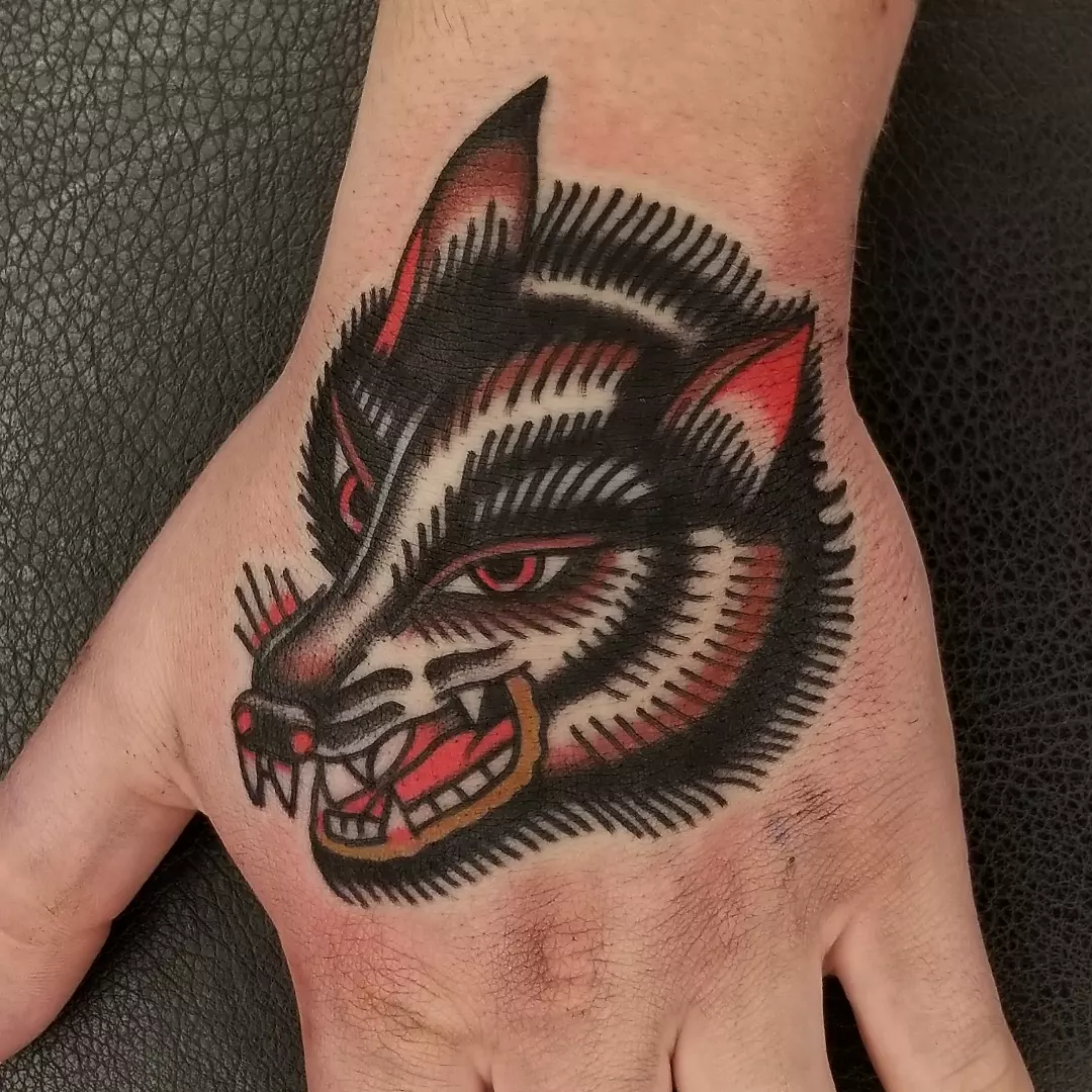 Wolf head American traditional tattoo on the hand by Deke Harms, Bend, Oregon