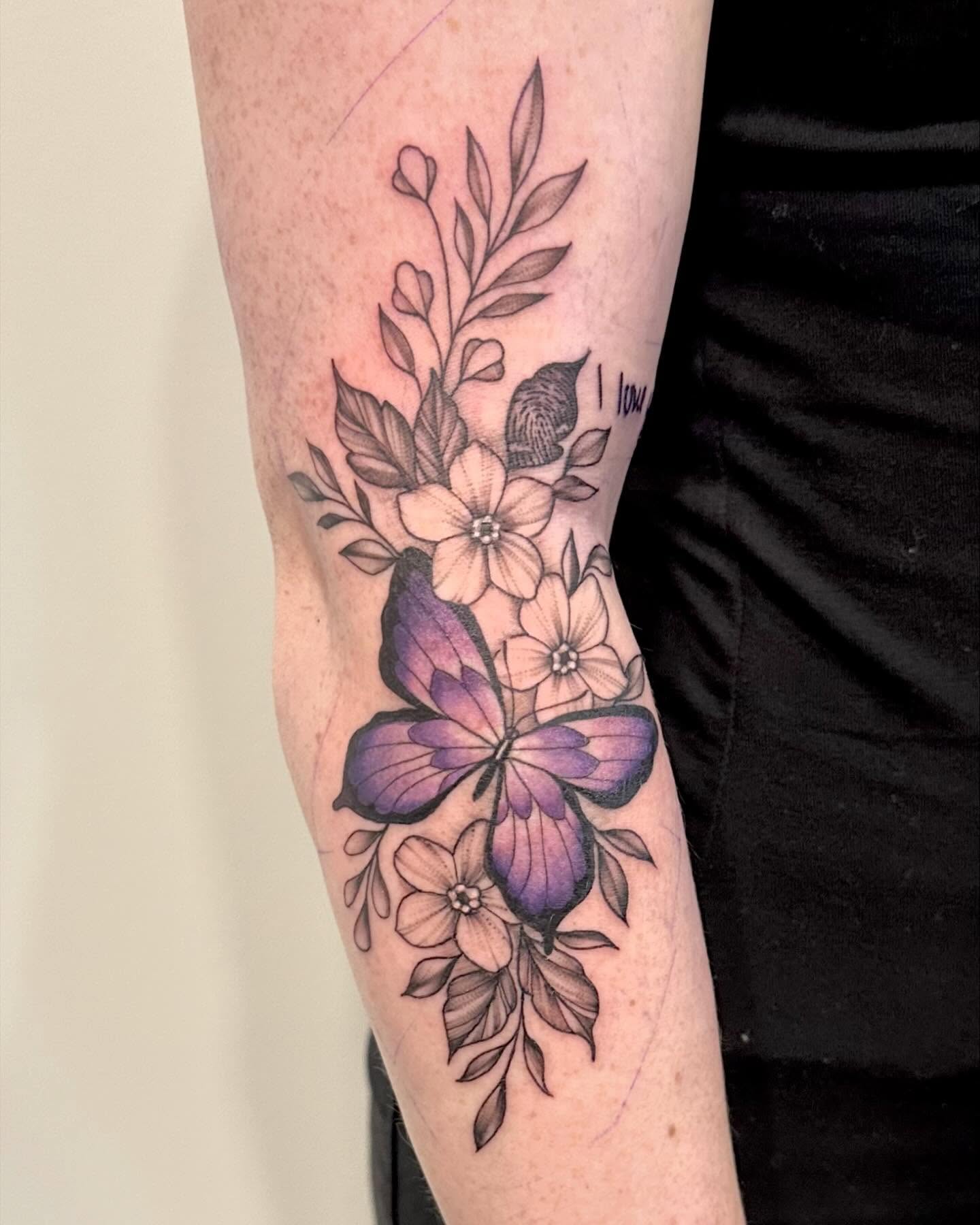 Butterfly and flowers new school tattoo on the forearm by Kate Darling