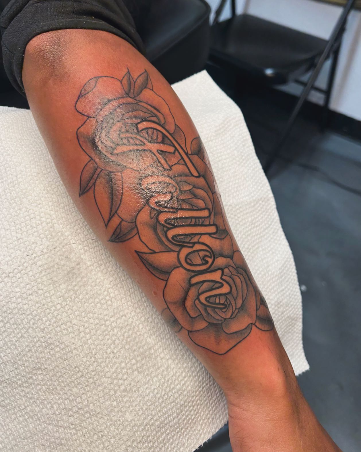 Rose and snake black and grey tattoo on the forearm by Tattoo Artist
