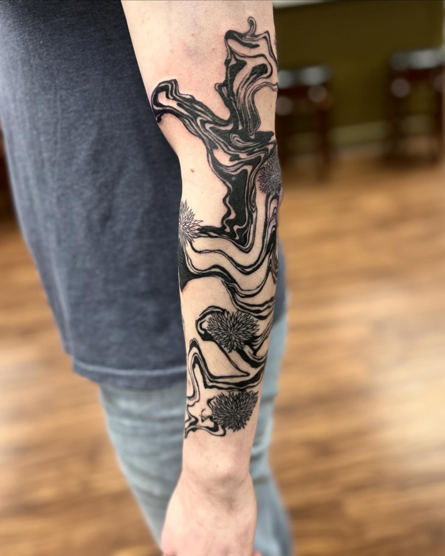 Abstract swirls black and grey tattoo on the forearm by Brittany Brutal