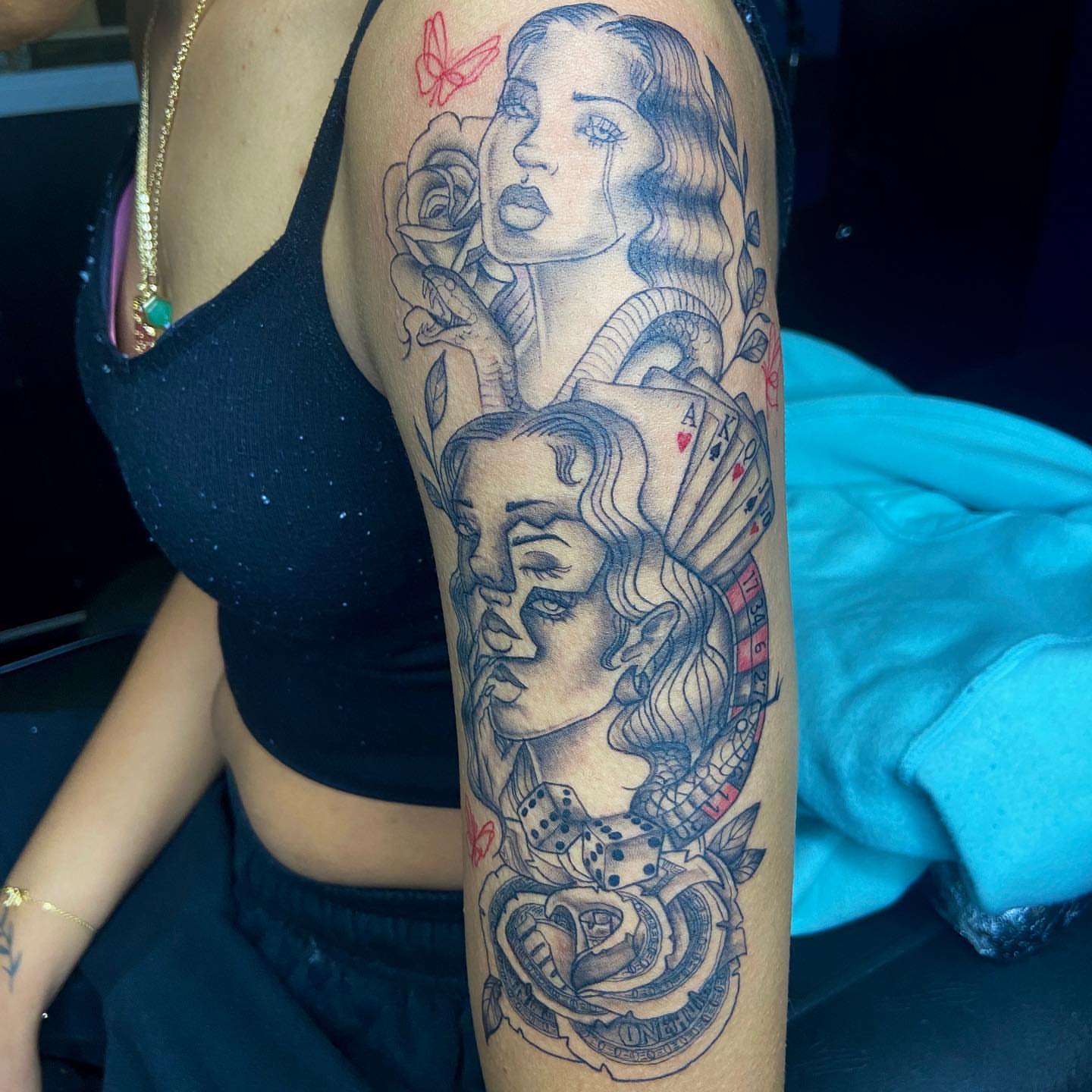 Woman with roses and playing cards American traditional tattoo on the forearm by Jess