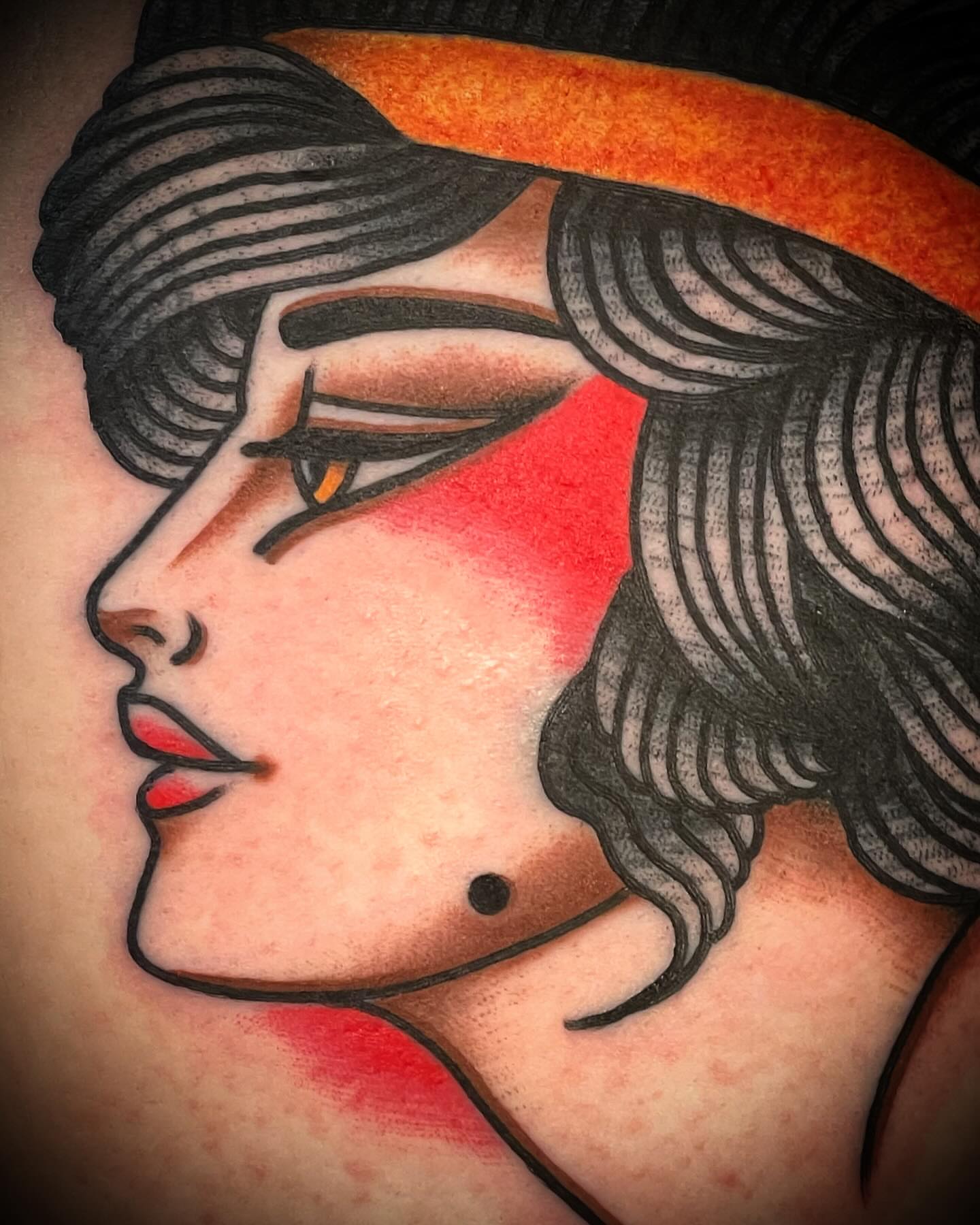 Woman's profile American traditional tattoo on the shoulder by Alex Muniz