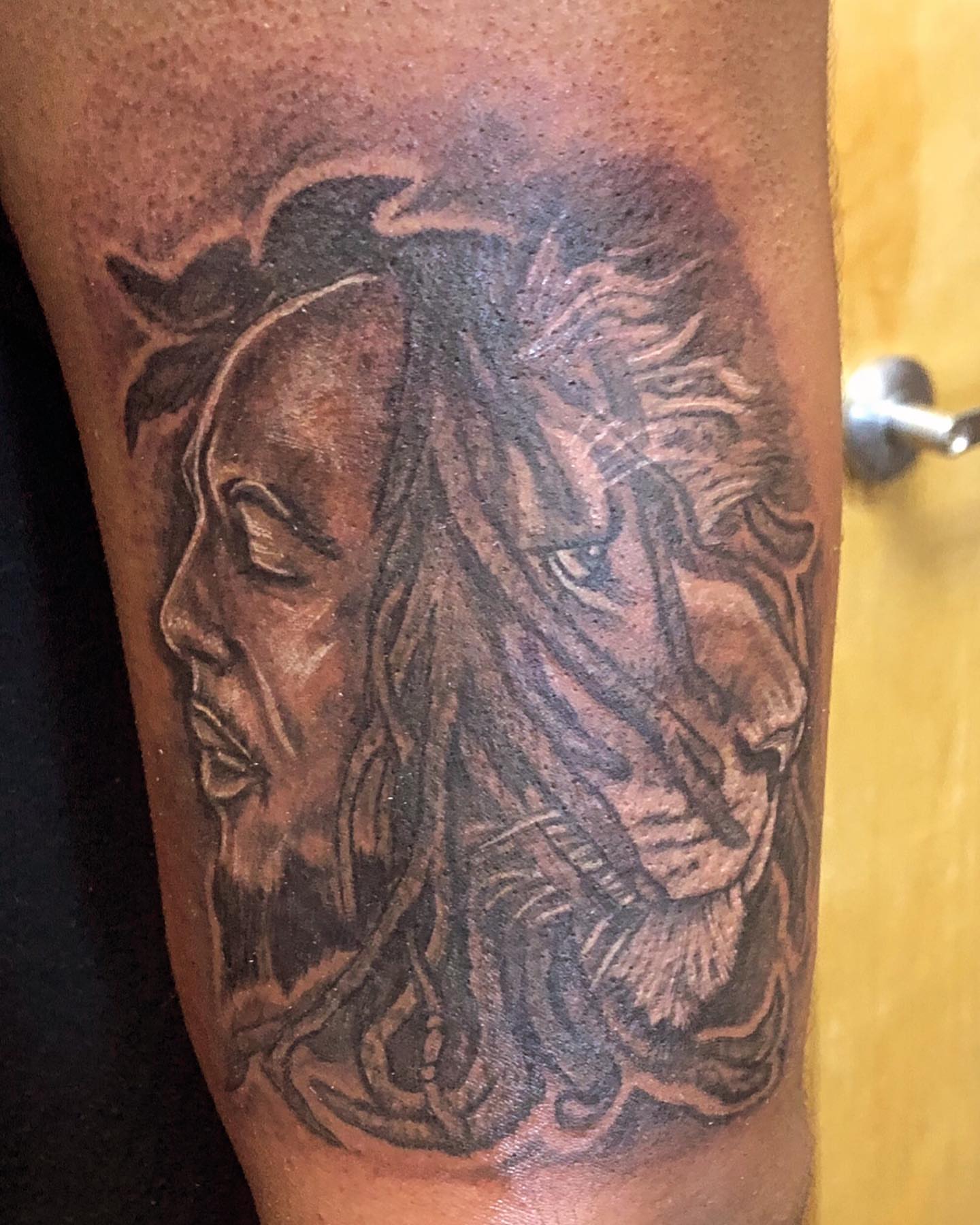 Lion and woman realism tattoo on the forearm by Adrian Shan Carr