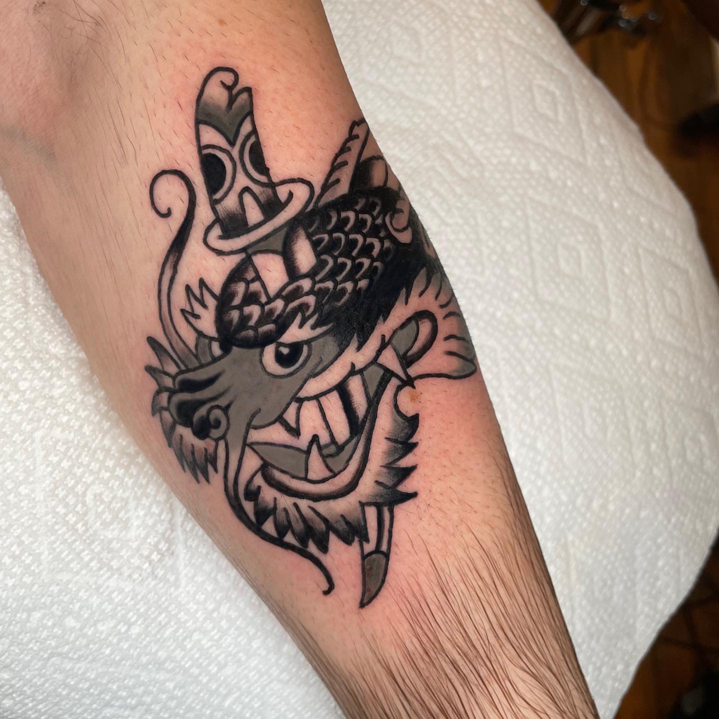 Dragon American traditional tattoo on the forearm by Emmy Gallagher