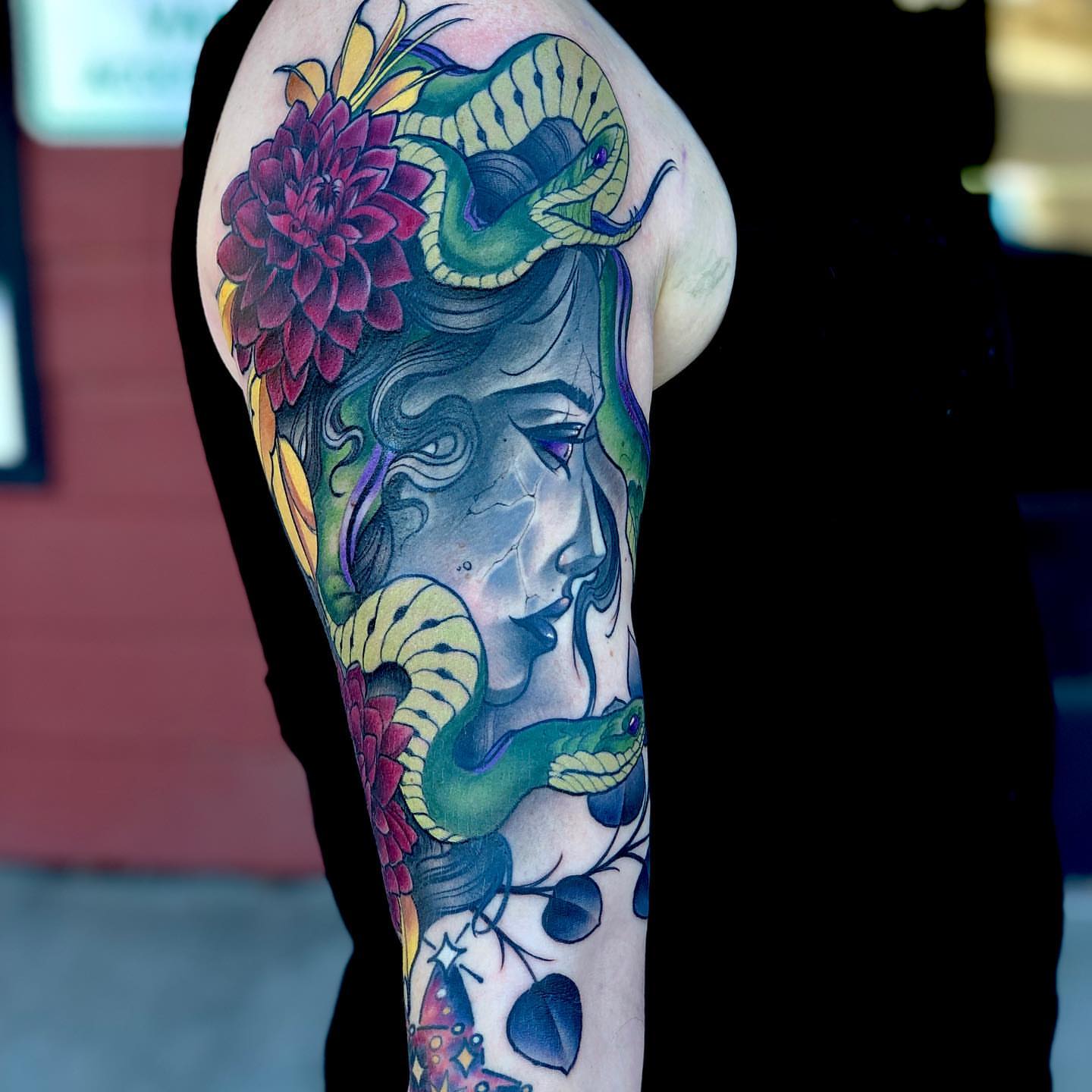 Woman with snake and flowers American traditional tattoo on the forearm by Aaron Borden