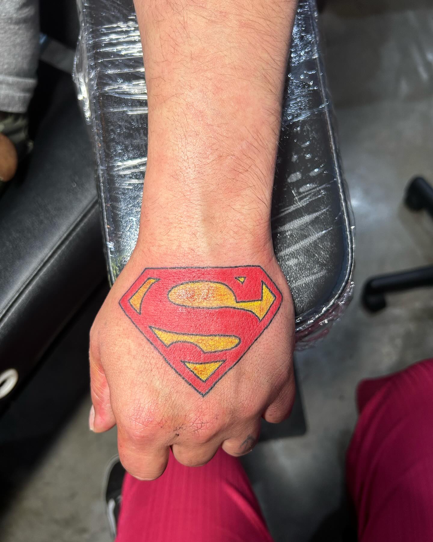 Superman logo American traditional tattoo on the hand by goose 🪿