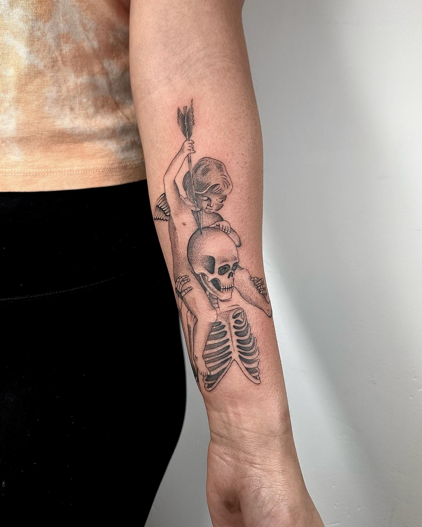 Child skeleton dotwork tattoo on the forearm by Fine line tattoo San Diego, San Diego, California