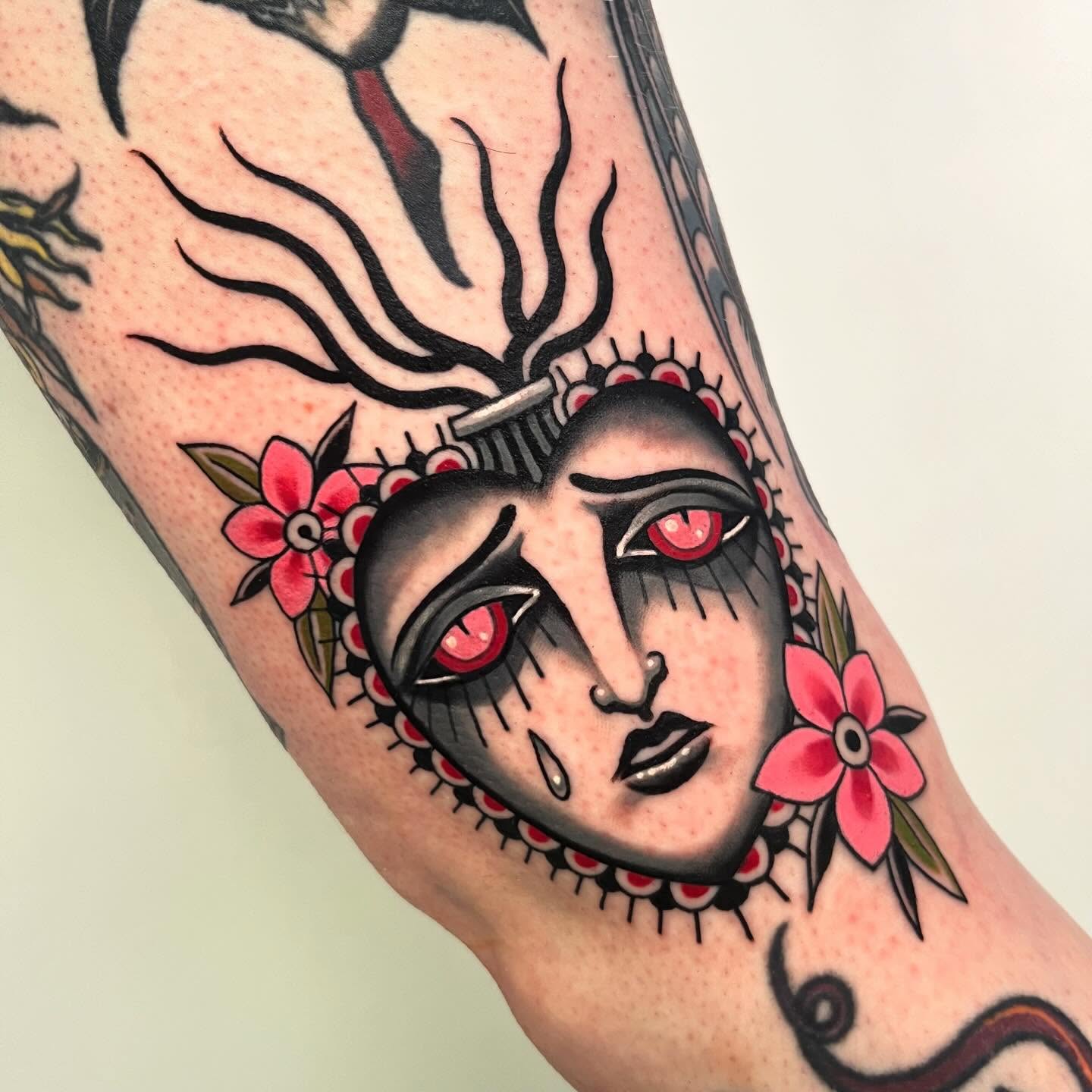 Woman's face American traditional tattoo on the forearm by Sara Lewis