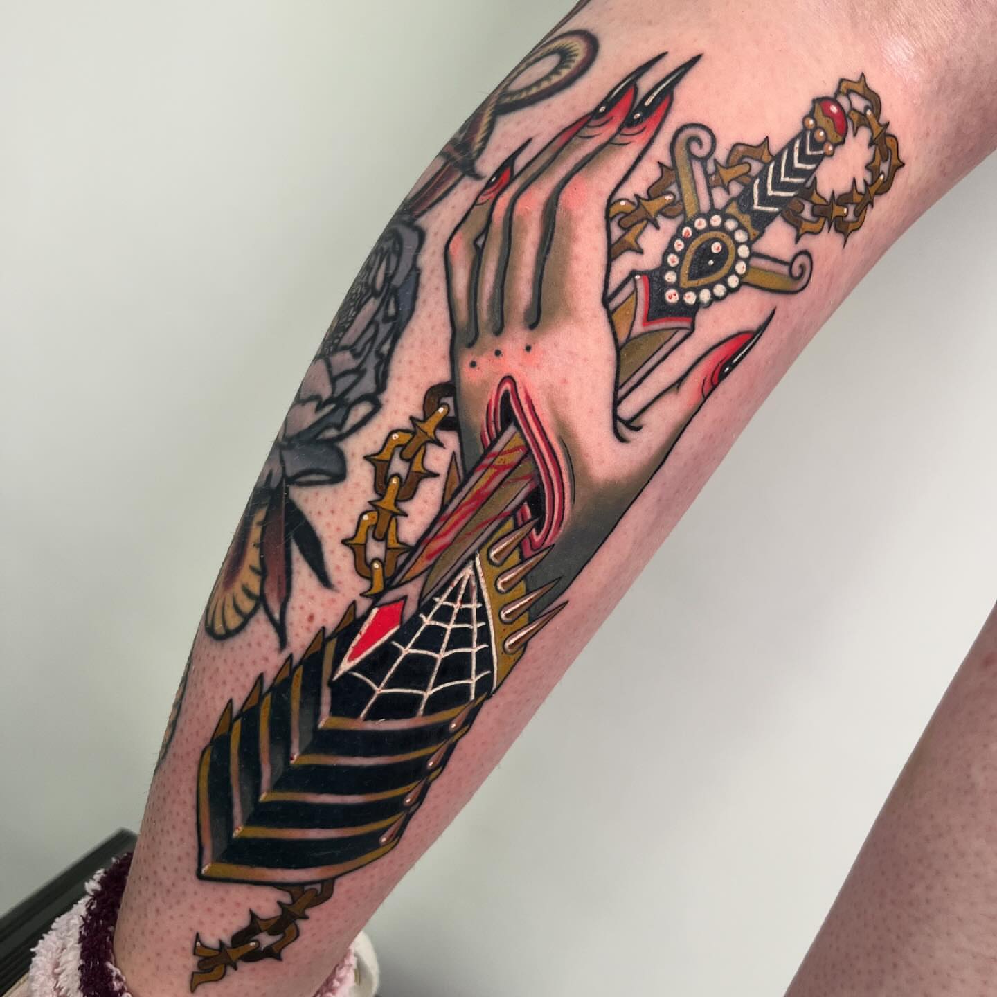 Hand with sword American traditional tattoo on the forearm by Sara Lewis