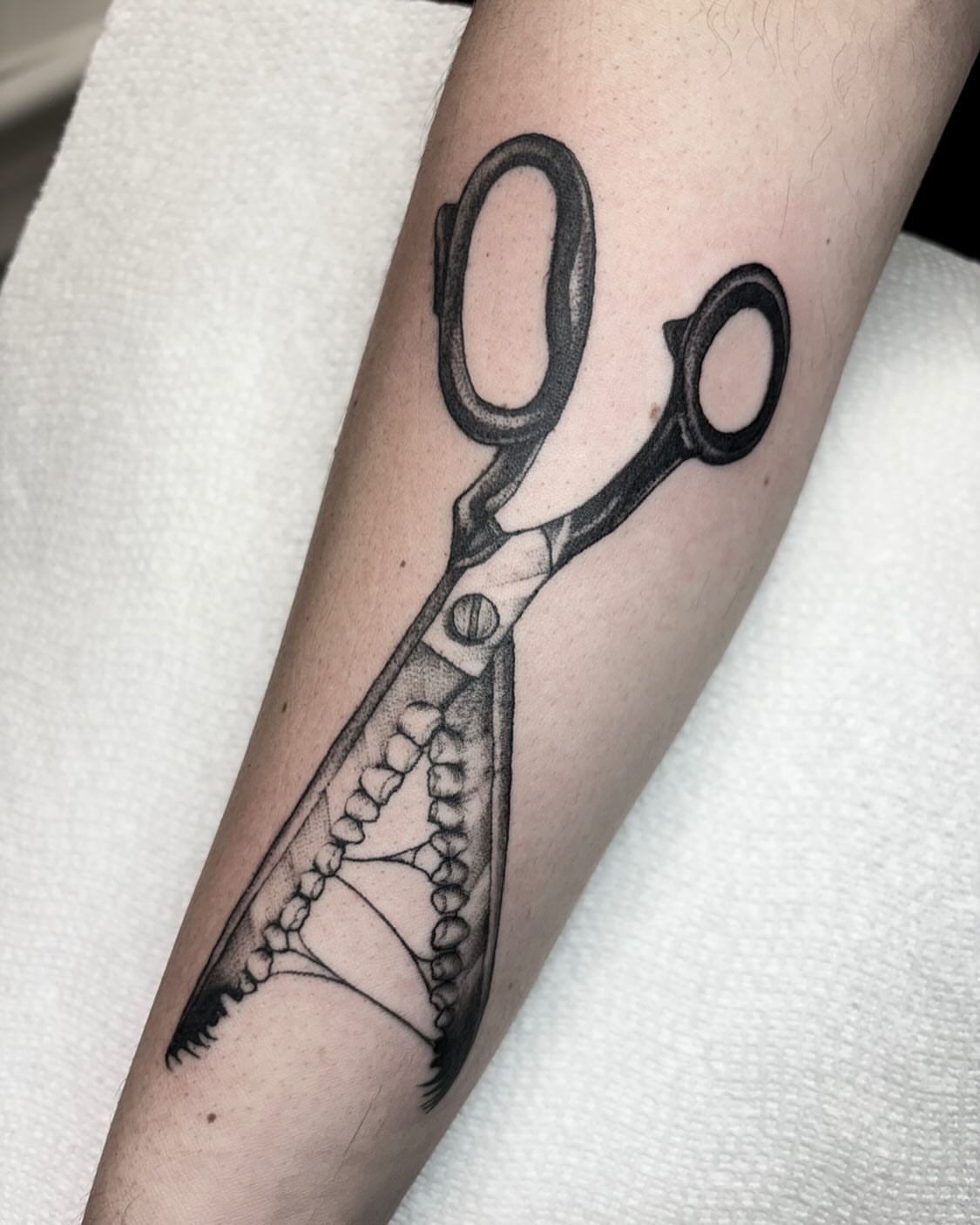 Scissors black and grey tattoo on the forearm by 𝐀𝐘𝐀𝐍𝐀𝐇