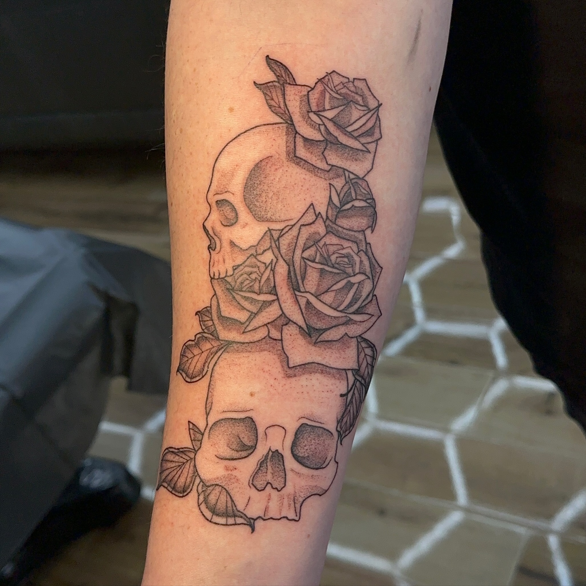 Skulls and roses realism tattoo on the forearm by alex h🪴 neotrad