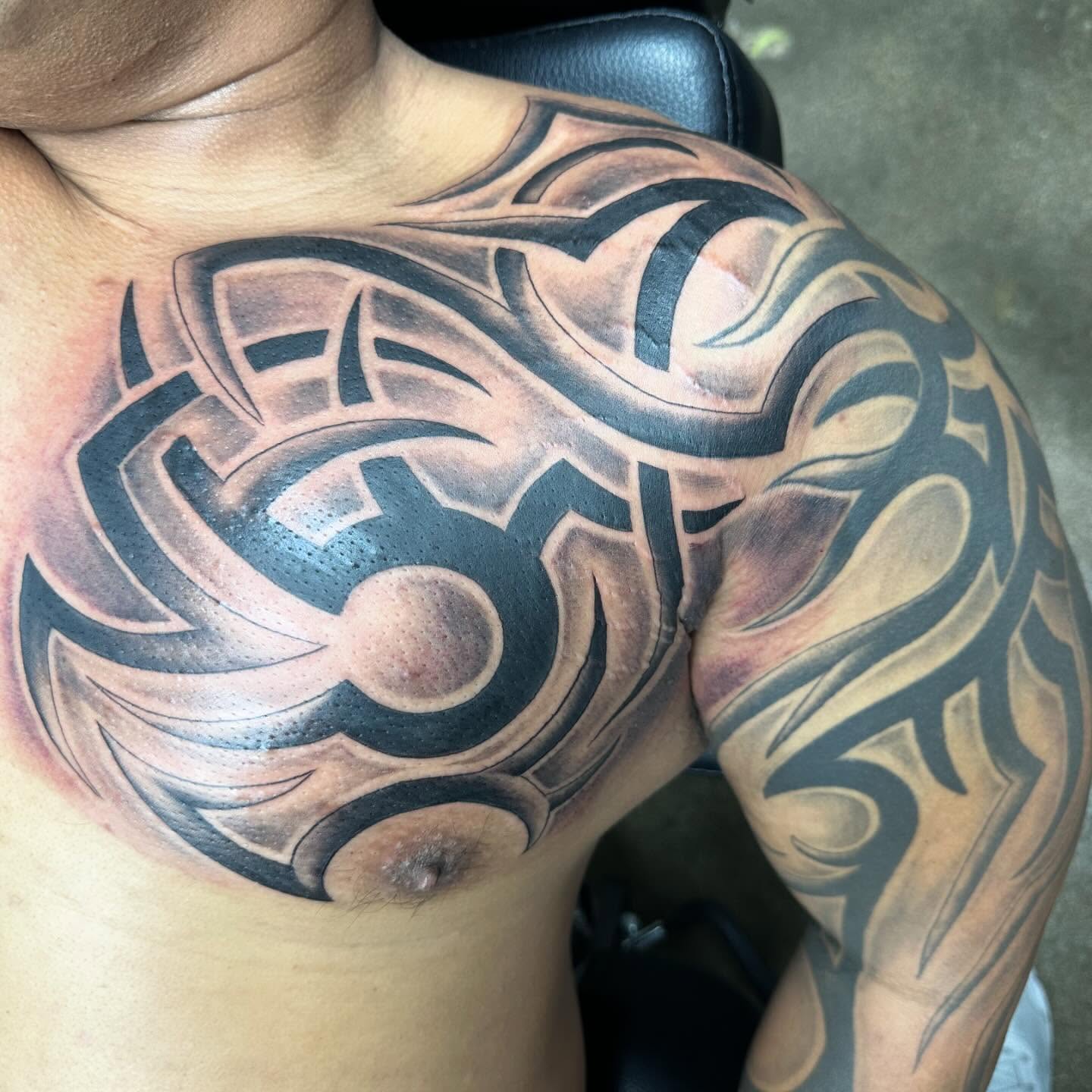 Tribal design tribal tattoo on the chest by Trevor Sibary