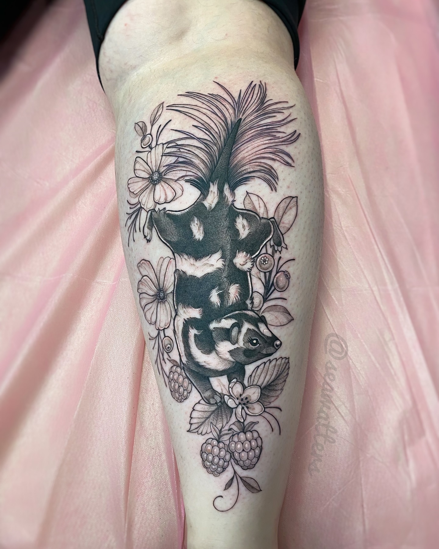 Badger and flowers black and grey tattoo on the forearm by Caitlin Watters