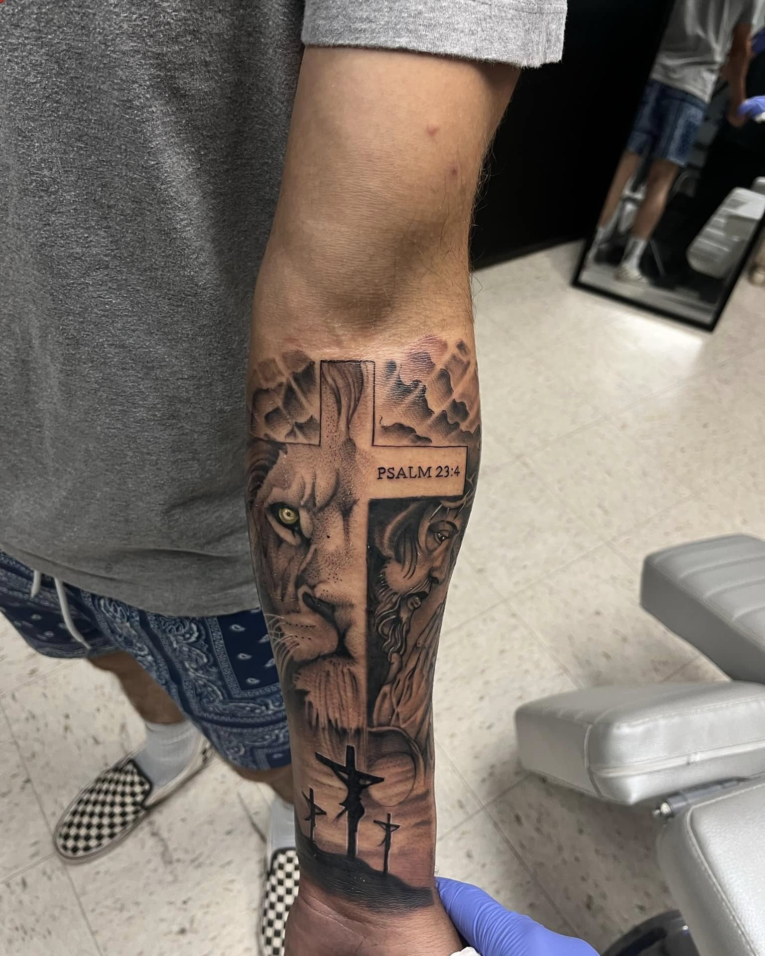 Lion and cross realism tattoo on the forearm by Chris_Tatt2_D’Ascenzo