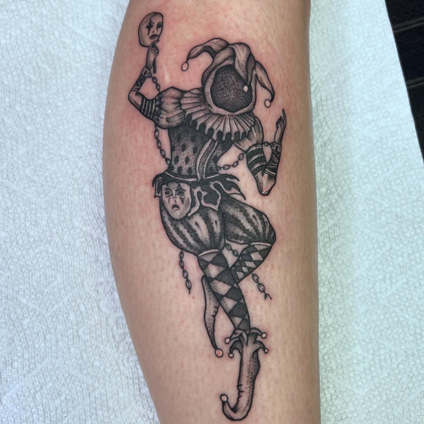 Clown jester black and grey tattoo on the forearm by Colby McClain