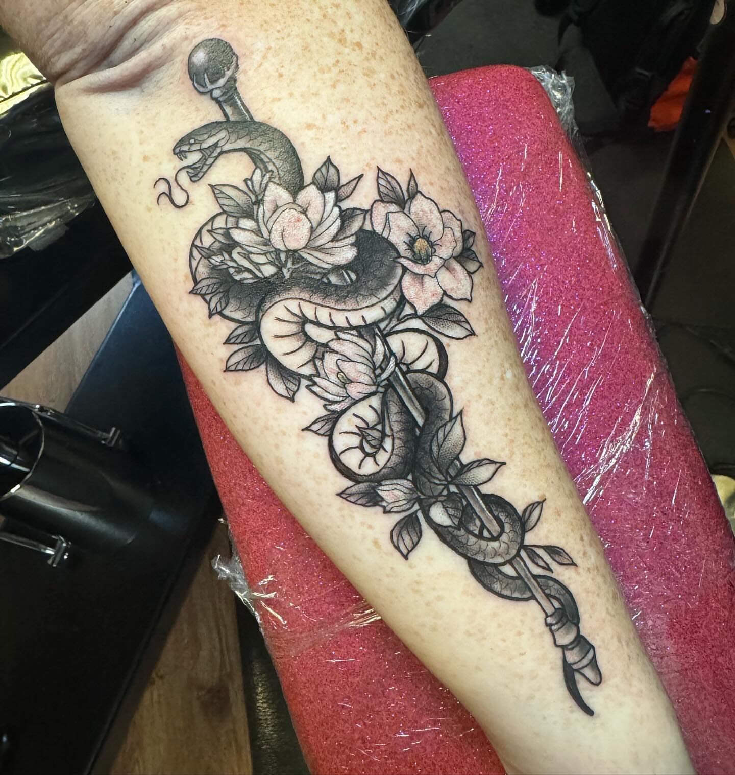 Snake and flowers black and grey tattoo on the forearm by ๐๏ธ, Ashland, Virginia