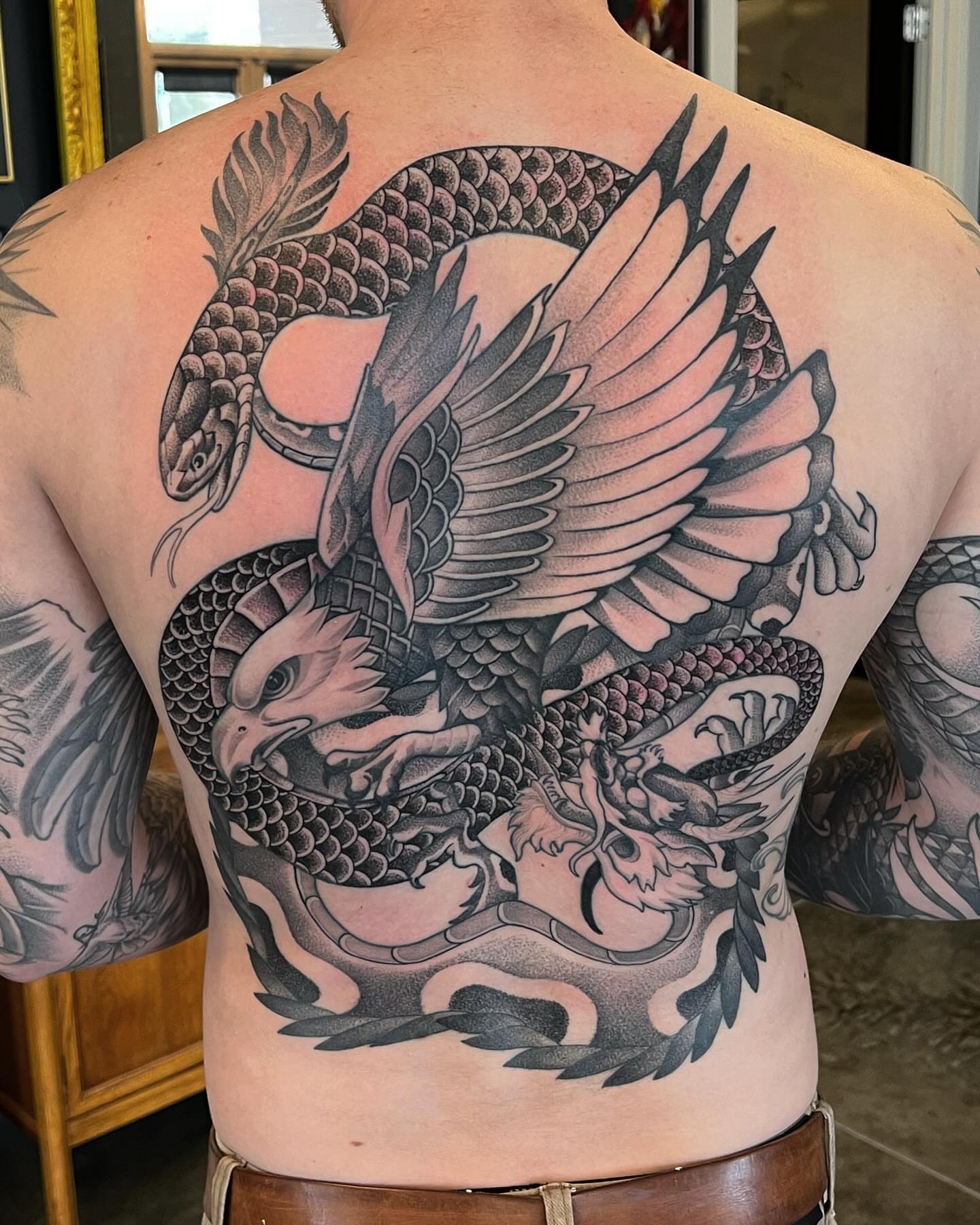 Dragon and phoenix realism tattoo on the back by Will Campbell