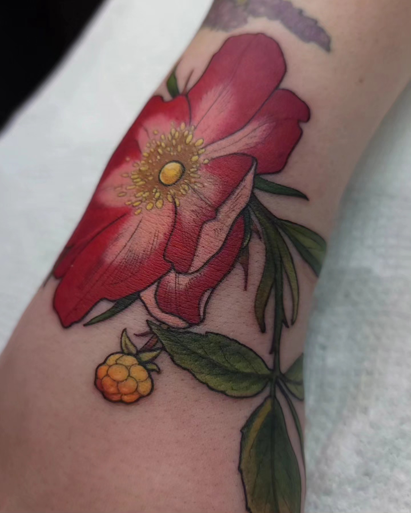 Flower and berry realism tattoo on the forearm by Ghost