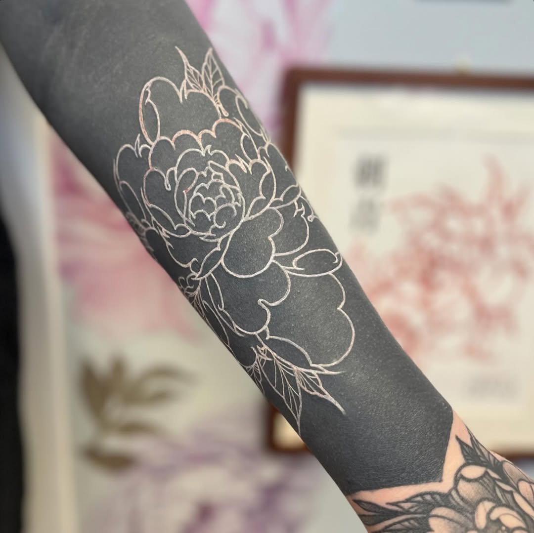 Peony flower outline Japanese tattoo on the forearm by Garden Glow Tattoo