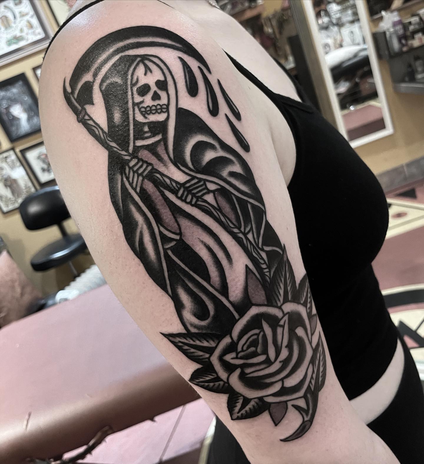 Reaper with rose black and grey tattoo on the forearm by Mike Hudgins
