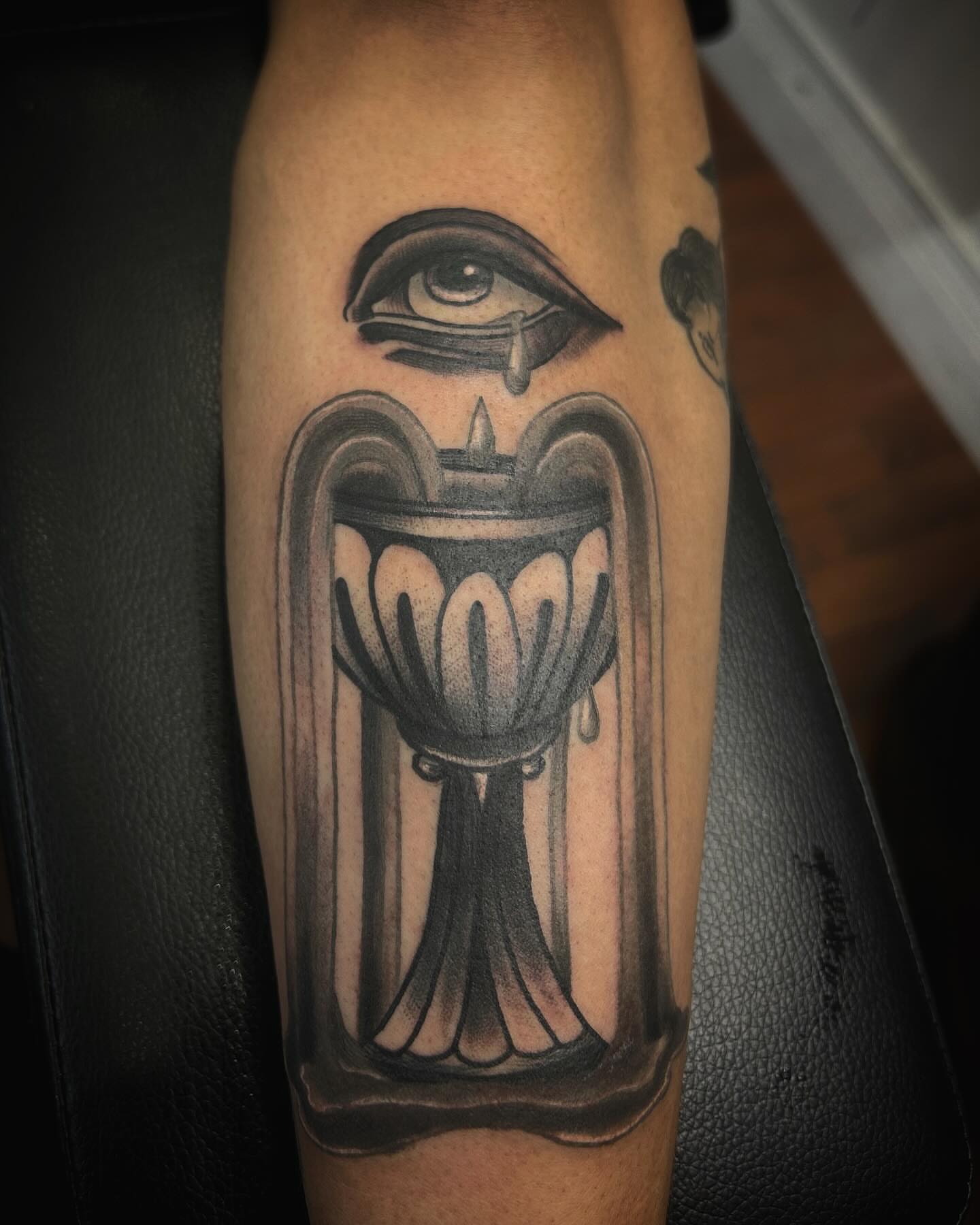 Eye and candle black and grey tattoo on the forearm by Samantha C, Bremerton, Washington