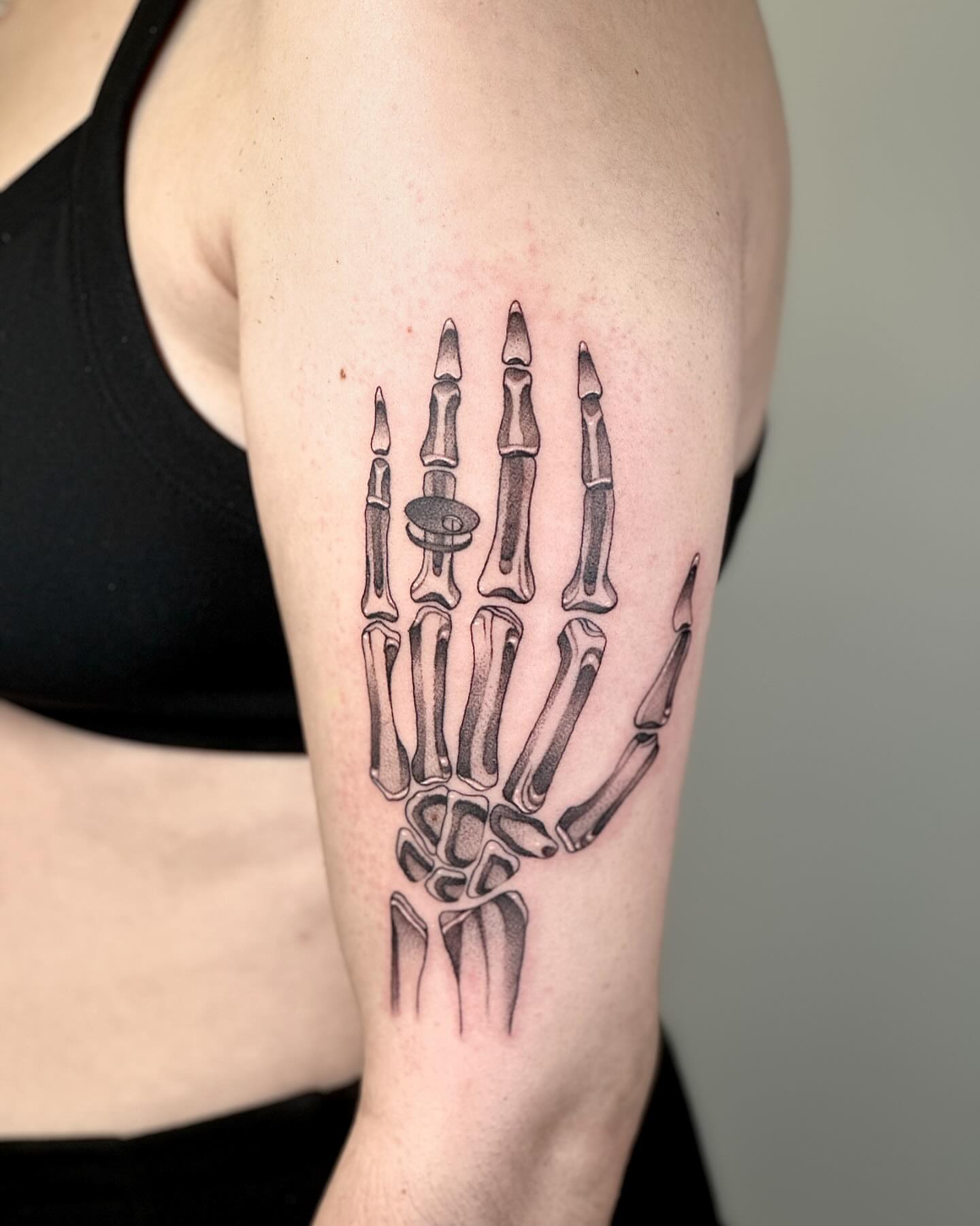 Skeleton hand black and grey tattoo on the forearm by Fine line tattoo San Diego, San Diego, California