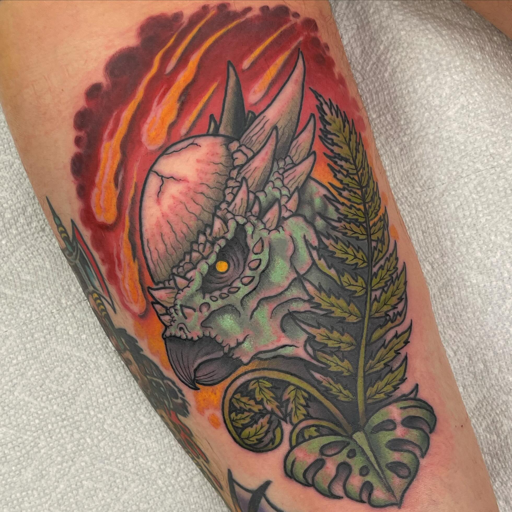 Dinosaur and fern American traditional tattoo on the forearm by David Gottschalk