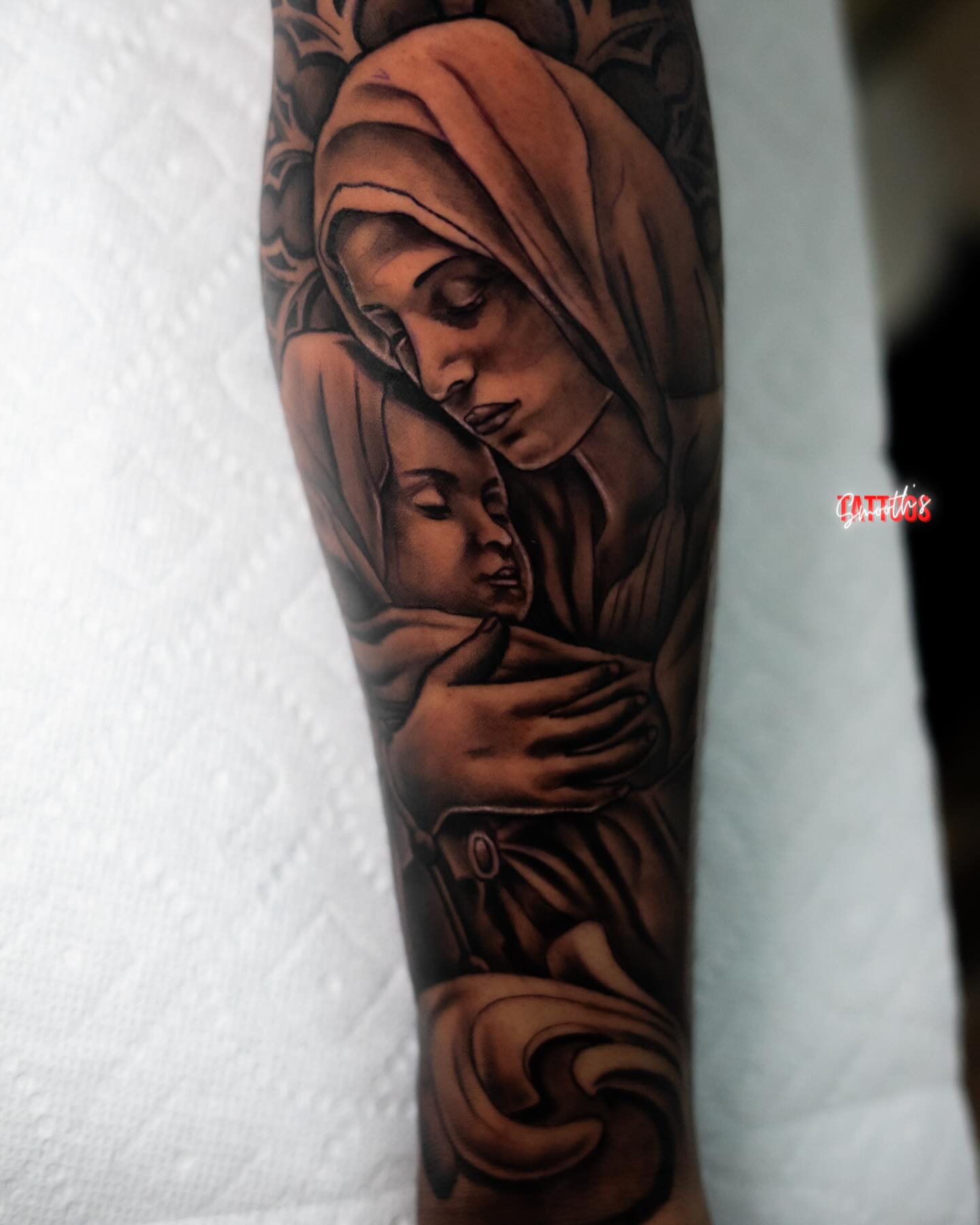 Mother and child realism tattoo on the forearm by Josh Acosta