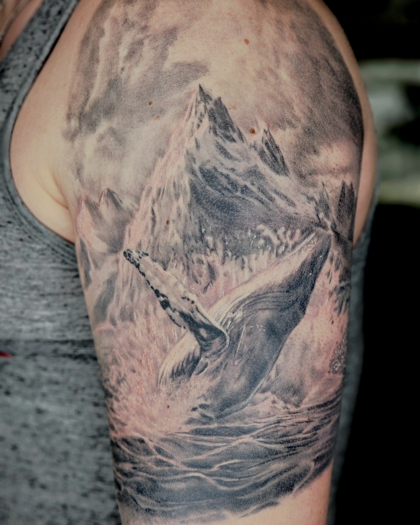 Mountain landscape realism tattoo on the upper arm by Zach Mullins